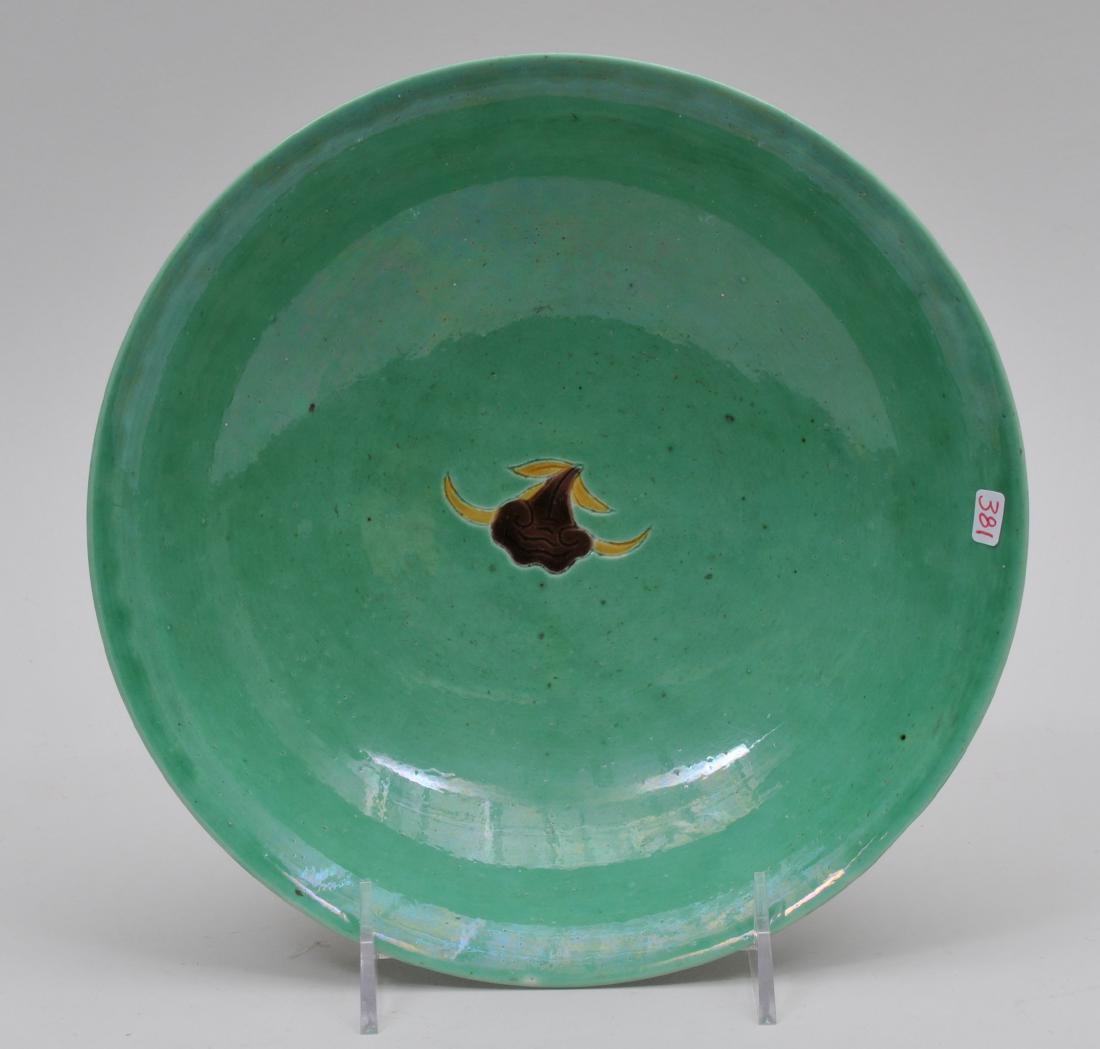 Porcelain bowl. China. 19th century. San Tsai: Porcelain bowl. China. 19th century. San Tsai decoration of flowering branches on green ground. Wan Li mark in underglaze blue on the foot. 8-5/8".