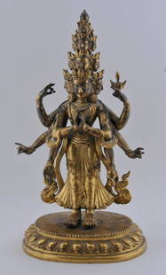 Gilt bronze Buddha. Sino-Tibetan. 18th century.: Gilt bronze Buddha. Sino-Tibetan. 18th century. Standing figure of Ekaduravalokitesh-vara. "The eleven headed thousand armed Kuan Yin". Jewelled inlays of coral and turquoise. 9-3/4" high.