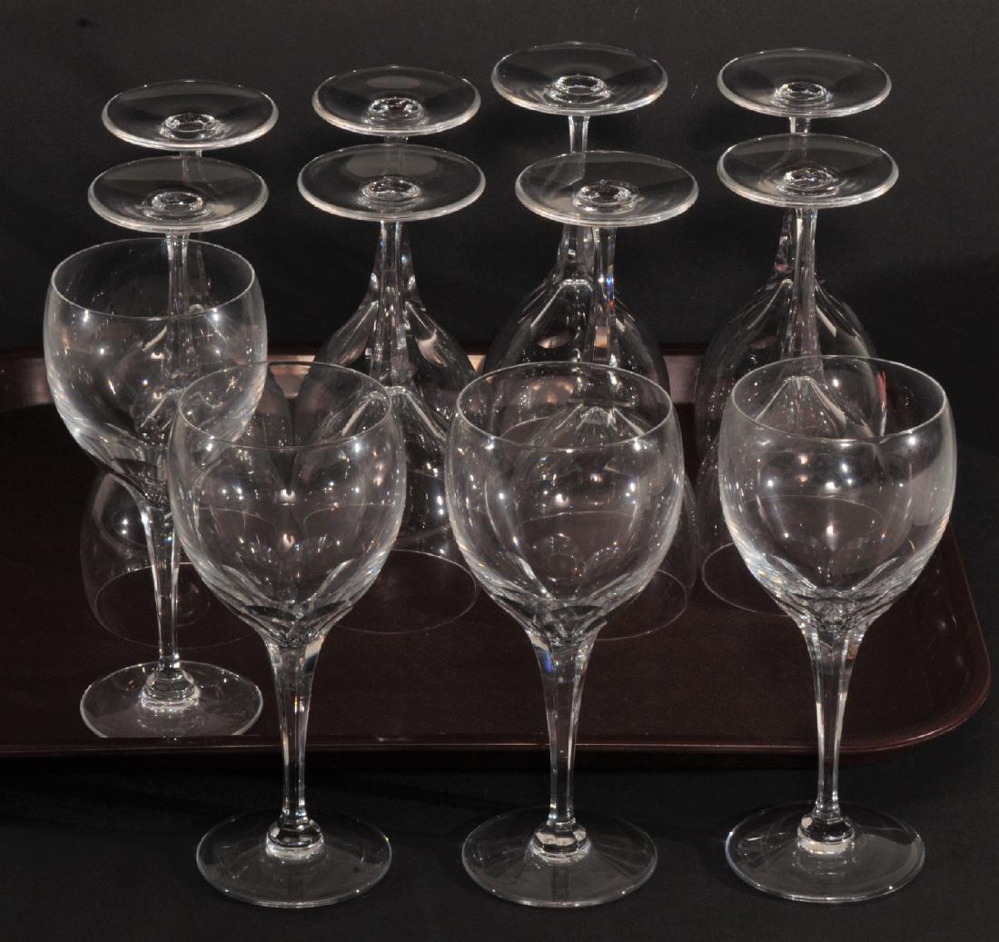 Twelve Lalique clear wine glasses with cut stems.