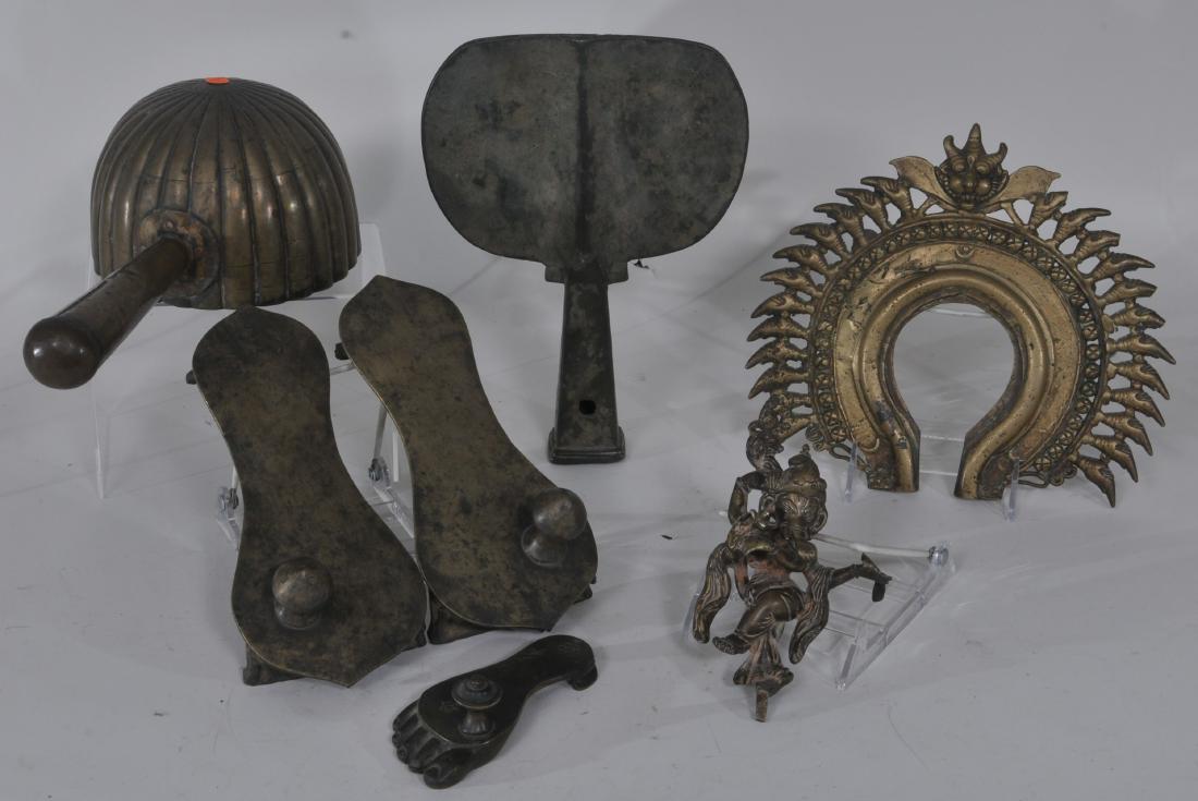 Lot of seven bronzes. India. 19th century. To include:: Lot of seven bronzes. India. 19th century. To include: A ladle, three votive sandals, a hoe and a halo. Largest- 13".