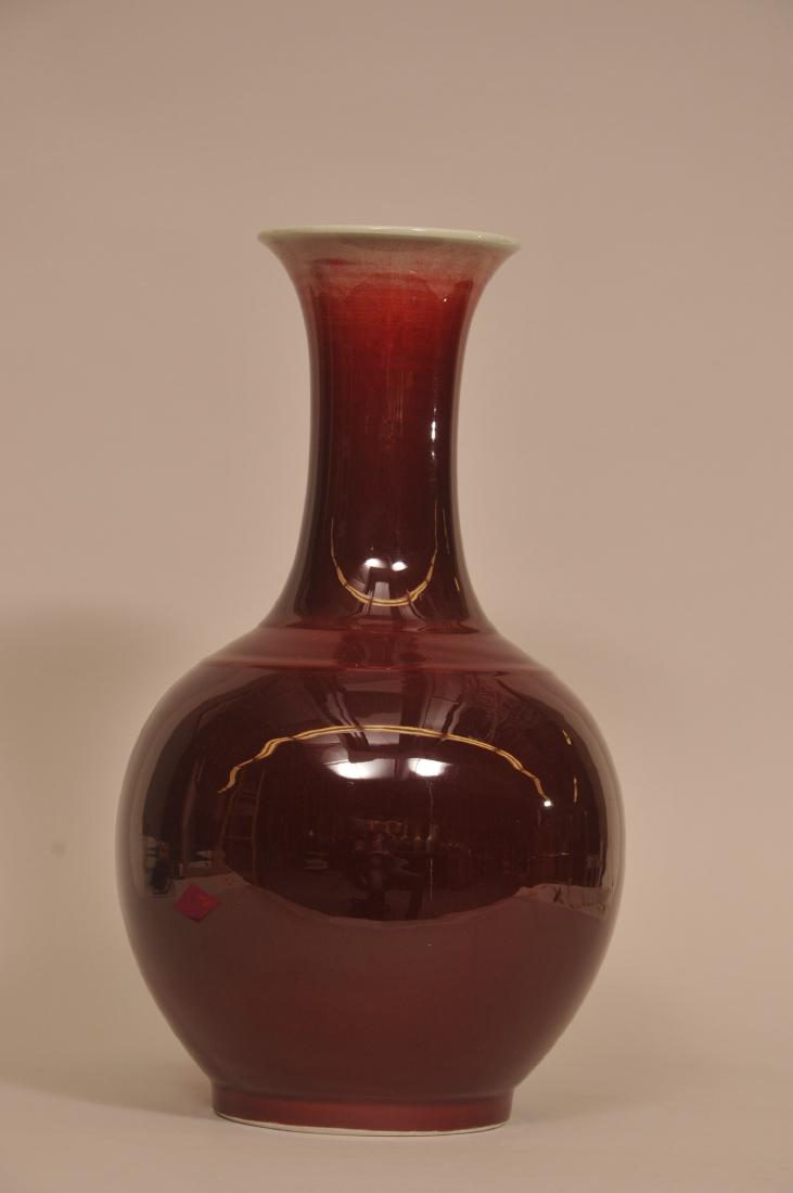 Porcelain vase. China. Kuang Tung six-character mark: Porcelain vase. China. Kuang Tung six-character mark and possibly of the period. Lang Yao glaze of deep red fading to white at the mouth. 17" high. Rim diameter. 5".