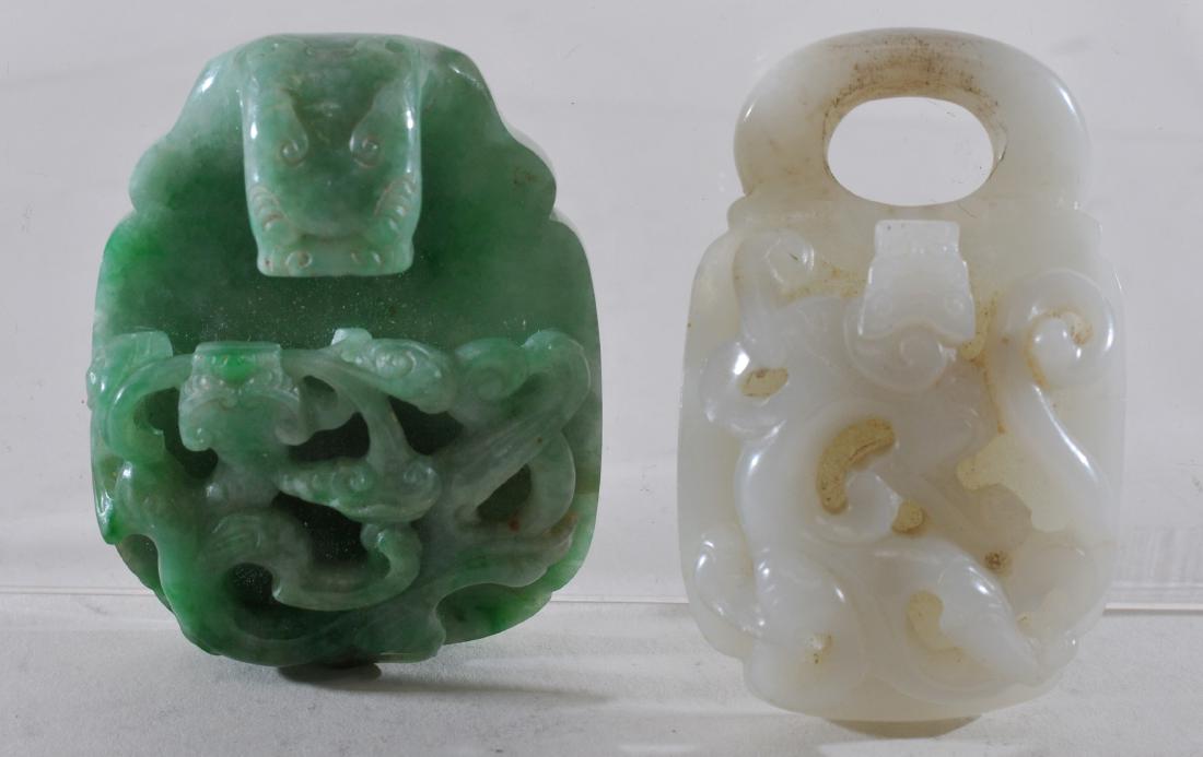 Two Jade garment hooks. China. 19th century. Chih Lung: Two Jade garment hooks. China. 19th century. Chih Lung decoration. One white and one green. Each about 2-1/4".