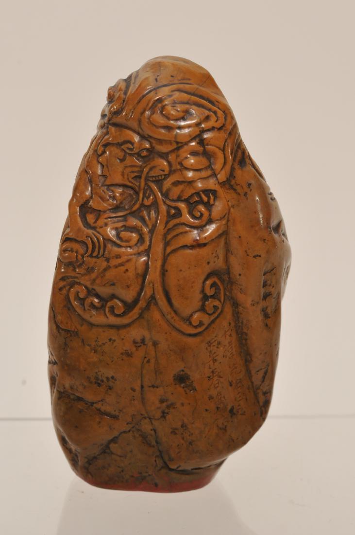 Soapstone seal. China. 19th century. Yellow wax stone.: Soapstone seal. China. 19th century. Yellow wax stone. Mountain shaped. Surface carved with a water dragon and clouds. Poem on one side. Seal intact. 4-3/4" high.