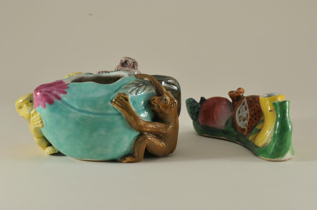Two porcelain water coupes. China. Early 20th century.: Two porcelain water coupes. China. Early 20th century. Famille Rose enamels. To include one with monkeys and peaches. The other with various fruits. Each about 4" long.