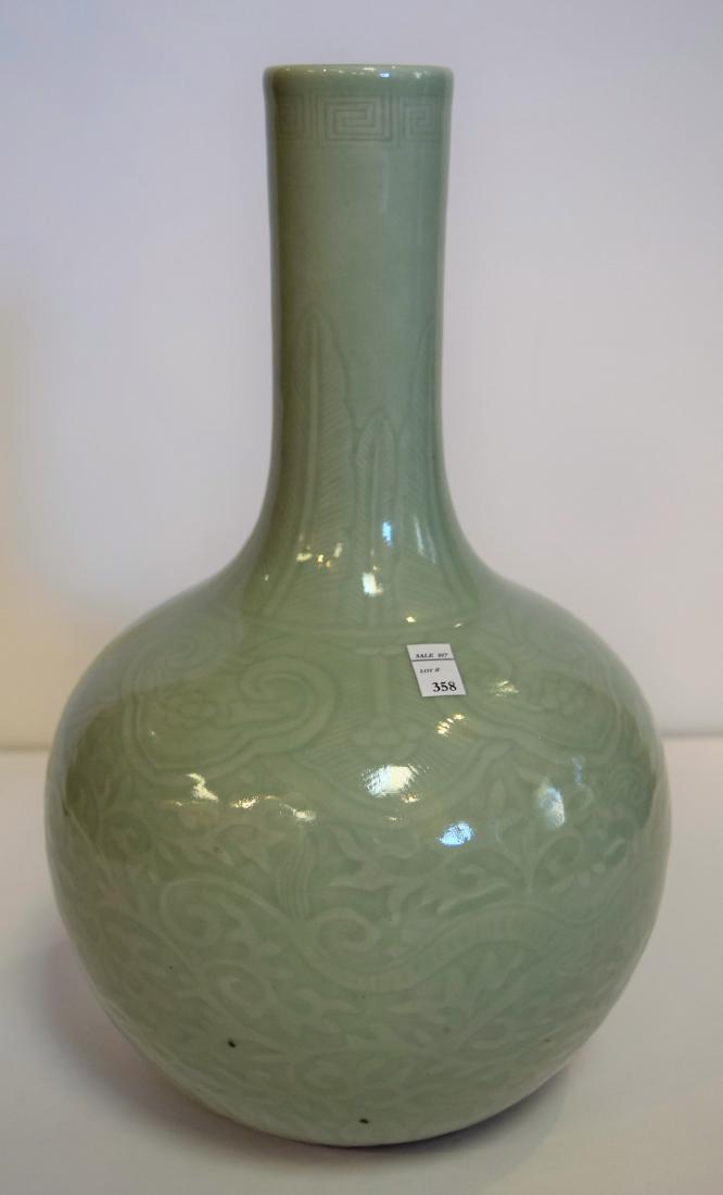 Porcelain vase. China. 19th century. Bottle form.: Porcelain vase. China. 19th century. Bottle form. Surface carved with dragons and Ling Chih. Sea green celadon glaze. 13".