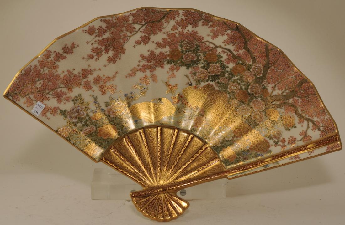 Stoneware dish. Japan. Meiji period (1868-1912).: Stoneware dish. Japan. Meiji period (1868-1912). Satsuma ware. Fan shaped. Decoration of peacocks and flowering trees. 20" x 13".