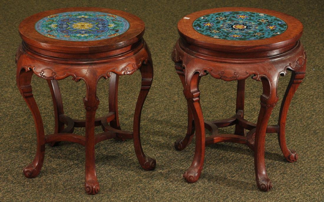 Pair of stools. China. 20th century. Carved rosewood: Pair of stools. China. 20th century. Carved rosewood inset with floral decorated cloisonné plaques. 19" diameter. 21" high.