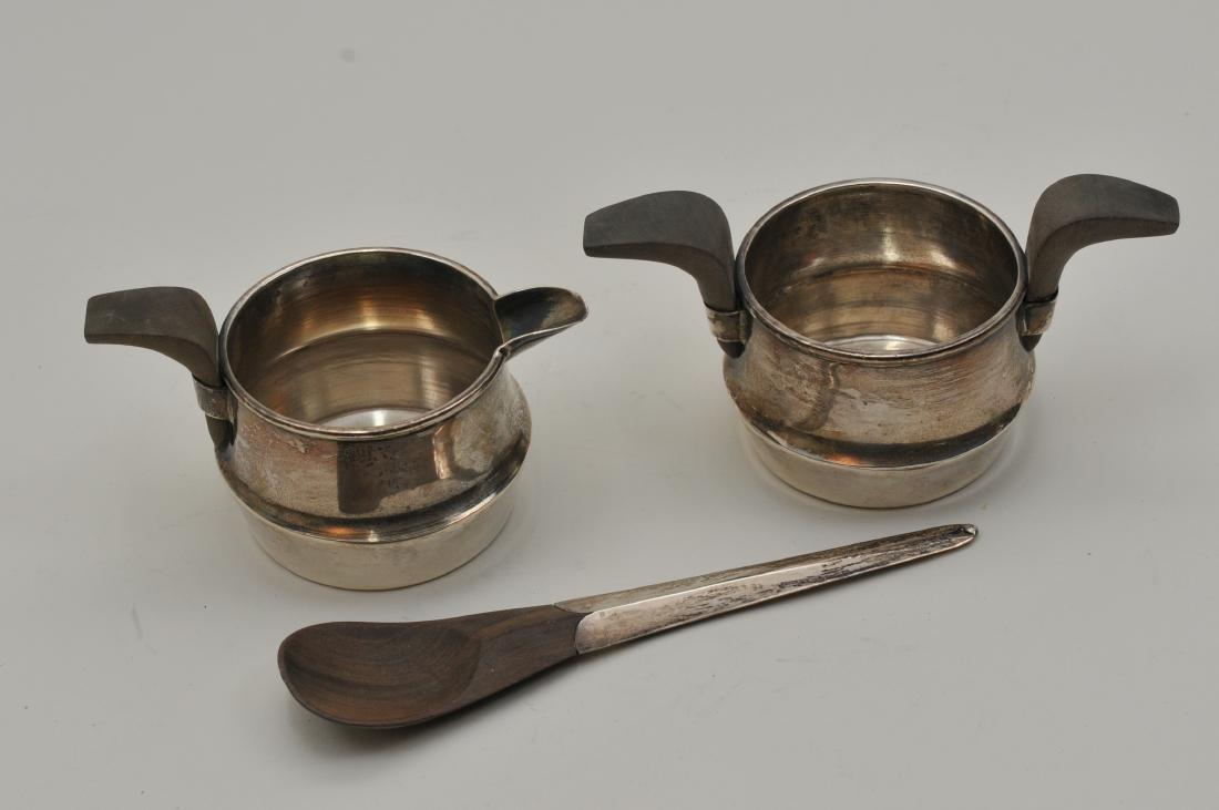 William Spratling. Mexico sterling silver modern design: William Spratling. Mexico sterling silver modern design creamer and sugar with silver handle wood sugar spoon. Wood handles. Marked on bases and spoon handles. Good condition. Sugar- 5" wide, 2-1/2" h