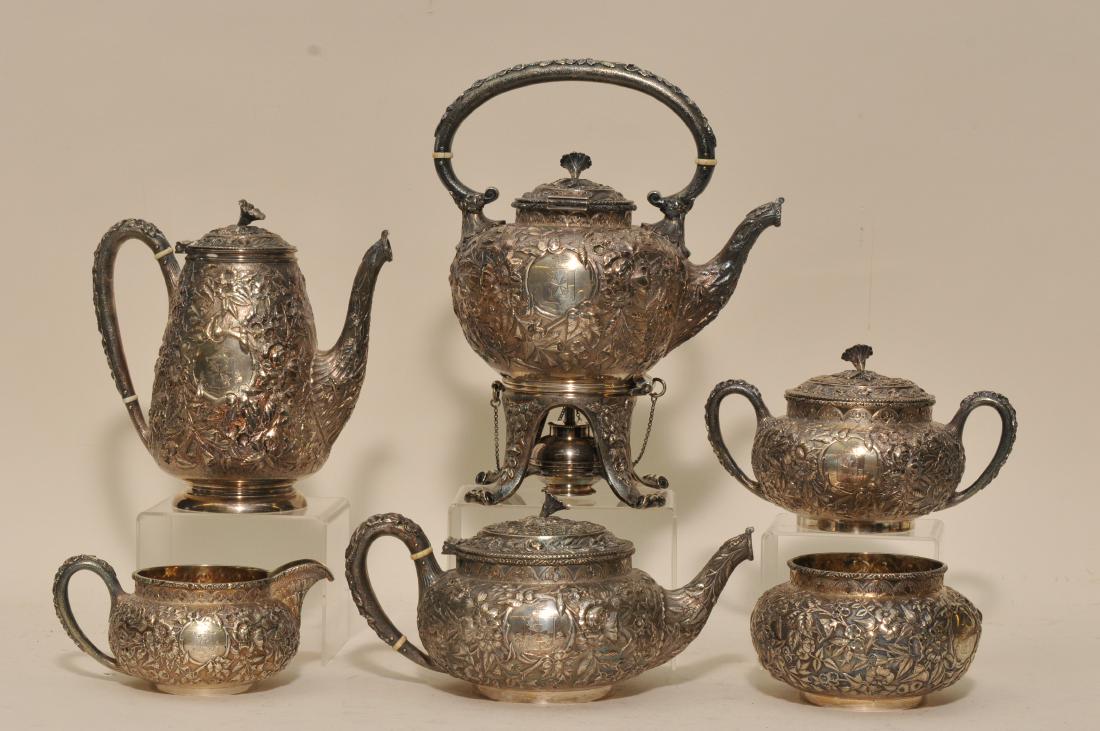 J.E. Caldwell & co. Philadelphia. Heavy sterling silver: J.E. Caldwell & co. Philadelphia. Heavy sterling silver six piece teaset with floral repousse decoration and armorial crests of eagle on shield and medieval cross. Banner reads "DIEV EST MA ROCHE". Te