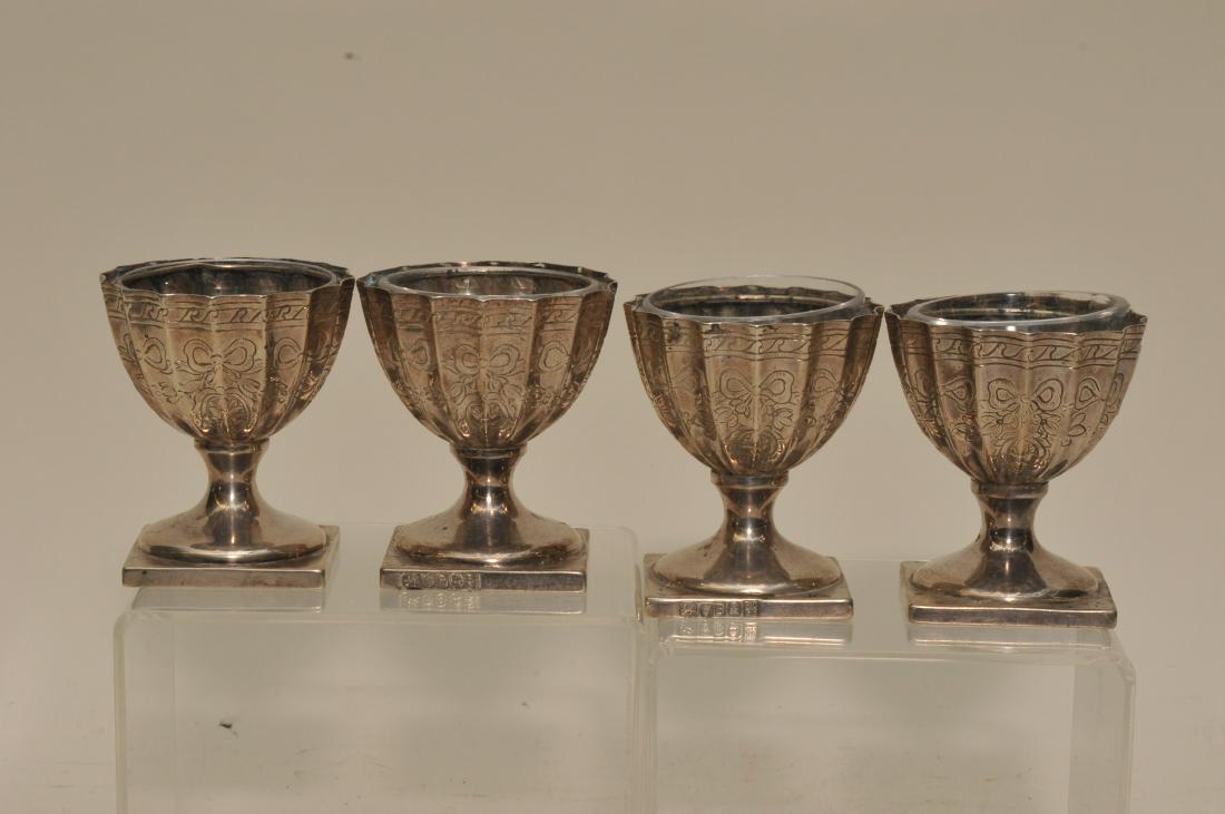Matching previous lot. Set of four English Georgian low: Matching previous lot. Set of four English Georgian low master salts. London makers Richard Crossley & George Smith. Date 1797-98. Four shell form master salts with clear glass removable liners. Some