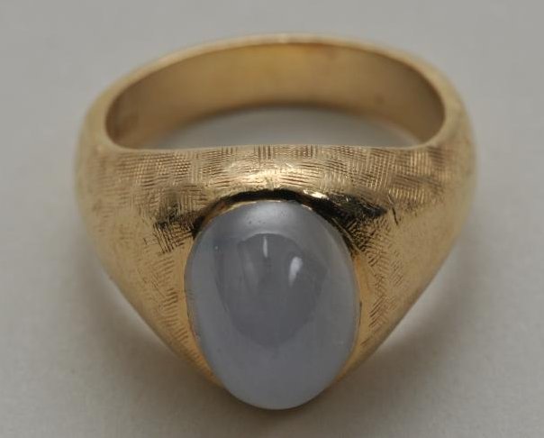 14k yellow gold star sapphire ring. Cabochon sapphire,: 14k yellow gold star sapphire ring. Cabochon sapphire, light blue in color. Gemstone measures approximately 11.2 x 8.2 x 10mm. Hallmarked 14k. Finger size 7. Total weight of 12.1 grams.