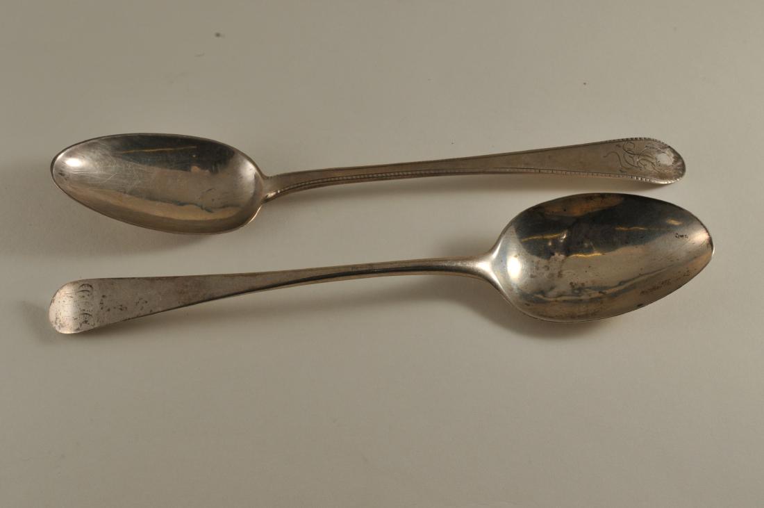 Two 18th century possibly American Colonial silver: Two 18th century possibly American Colonial silver table spoons. (1) Table spoon with monogrammed handle with decoration on one side of handle. Hallmarked ER and a lion passant. Good condition. End of