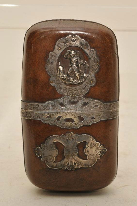 Antique Silver decorated leather cigar case. Applied: Antique Silver decorated leather cigar case. Applied silver banding and figural scene of a hunter and dog. Hallmarked AP. Good condition. 5-3/4" x 3-1/4".