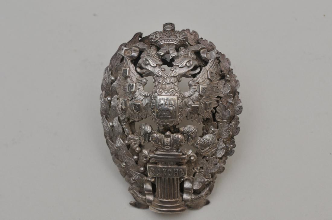 19th/20th century Russian silver heavy hat ornament.: 19th/20th century Russian silver heavy hat ornament. Russian Imperial double eagle and floral garland decoration. Crown above double eagle. Russian inscription. "Zachon" ? On pillar. Hallmarked with .