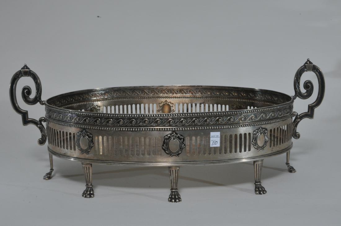 German .800 silver large two handle oval pierced: German .800 silver large two handle oval pierced decorated claw footed serving dish. Missing glass liner. Inside base rim carved away on edge beneath handles. 17-1/2" wide. 26.8 ozt. Added silver plat