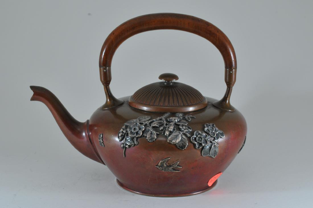 Georgian Aesthetic style mixed metals copper teapot: Georgian Aesthetic style mixed metals copper teapot with applied sterling silver floral branches, butterflies and a bird. Shallow dent on top of body. Wear and light scratching to patina. Small shallo