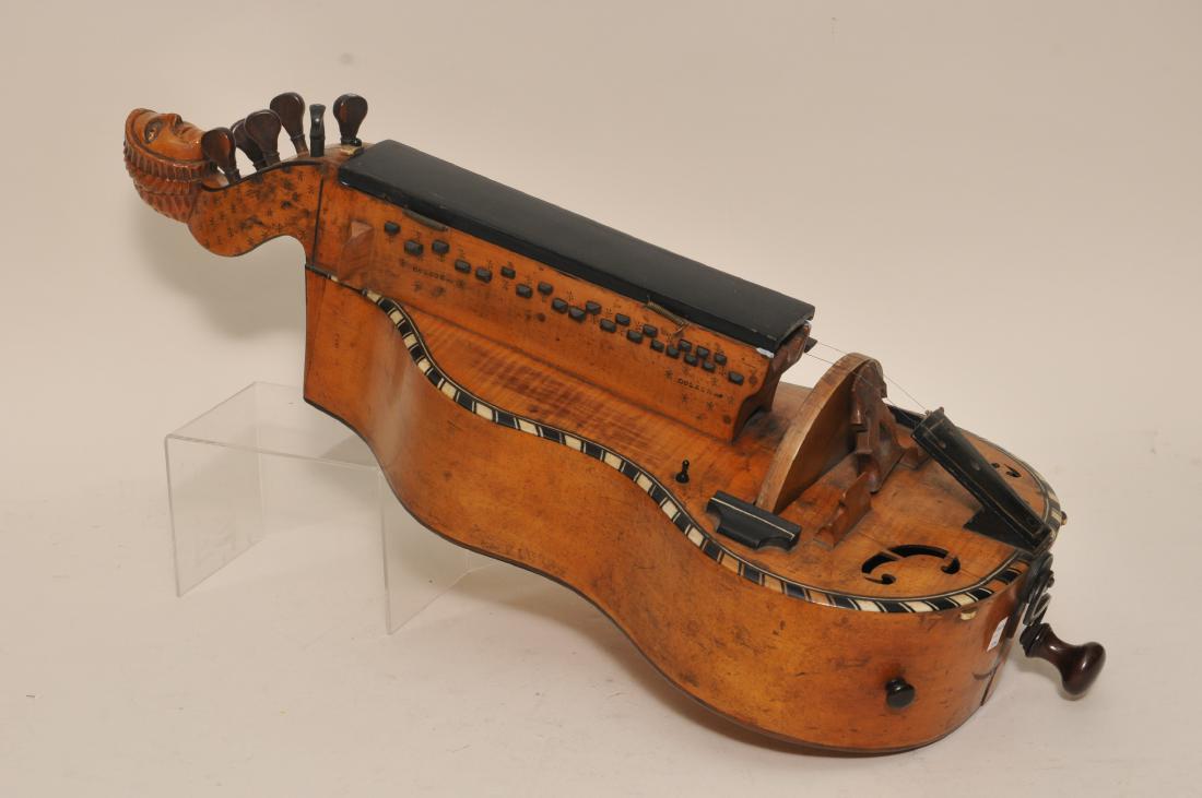 Colson early 19th century Hurdy Gurdy carved figural: Colson early 19th century Hurdy Gurdy carved figural head scroll. Snowflake punching. Bone and ebony border. Signed twice. Crank works. Cracks and restoration. 26" long.
