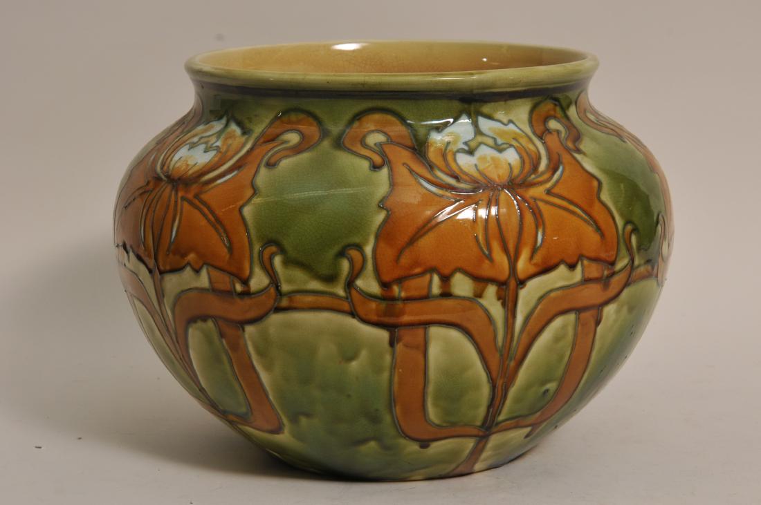 Large Minton pottery carved leaf decorated green ground: Large Minton pottery carved leaf decorated green ground Majolica round jardinière. Signed on base. 1" tight spider hairline on interior body. 14" wide. 10-1/2" high.