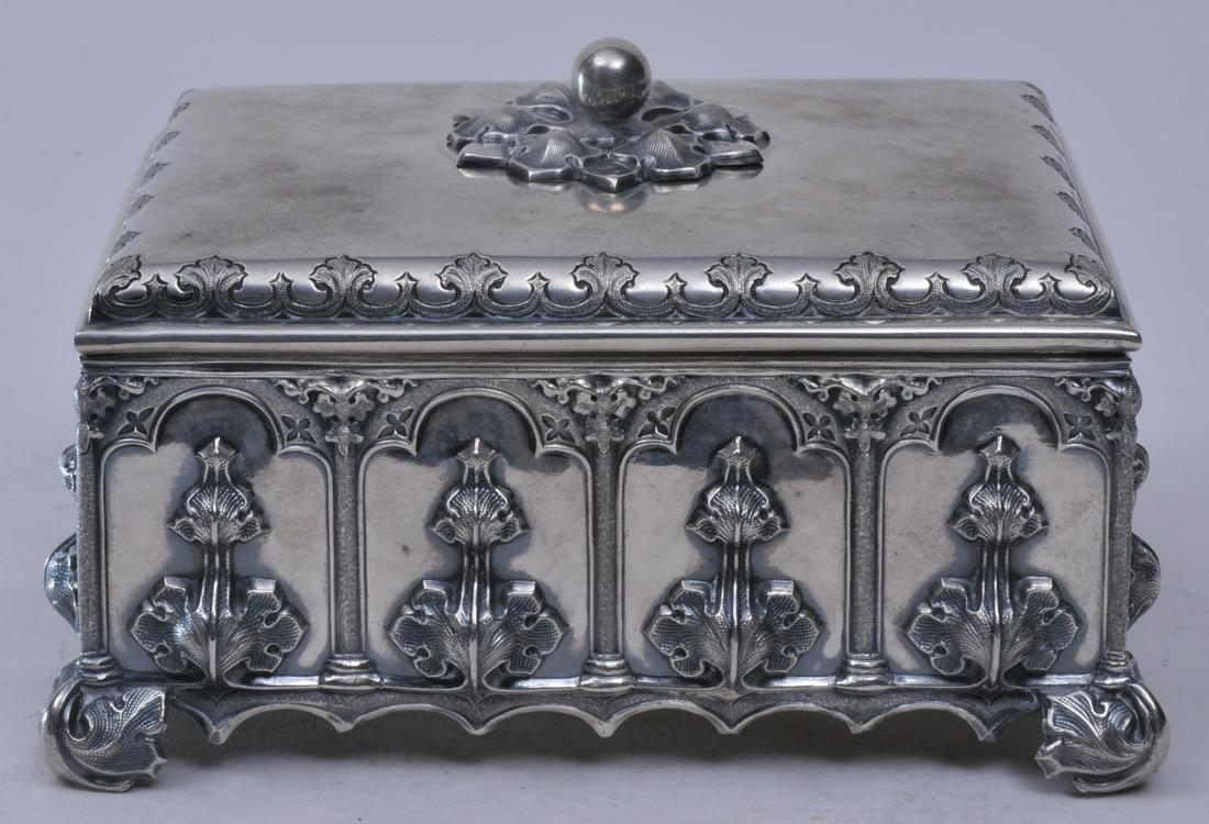 19th century Continental silver Gothic decorated: 19th century Continental silver Gothic decorated rectangular covered box. Gothic panels with raised leaf decoration. Leaf form feet. Cut out Gothic base. Engraved decoration. Unmarked. 6-1/2" wide. 3-