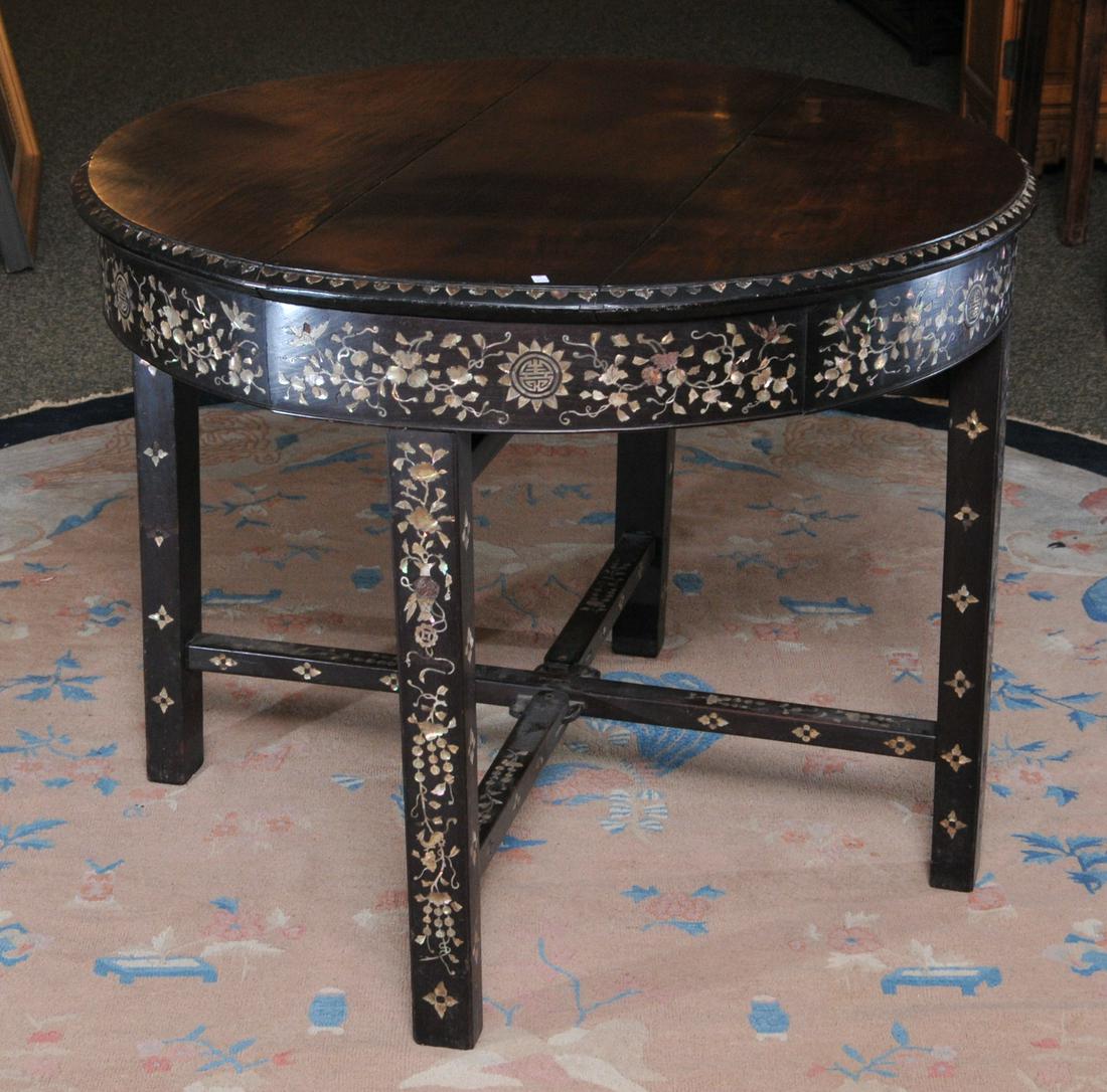 Round table. China. 19th C. Decoration of flowers: Round table. China. 19th C. Decoration of flowers inlaid in mother of pearl. 39"D x 30"H. Some inlay losses, stains to top.