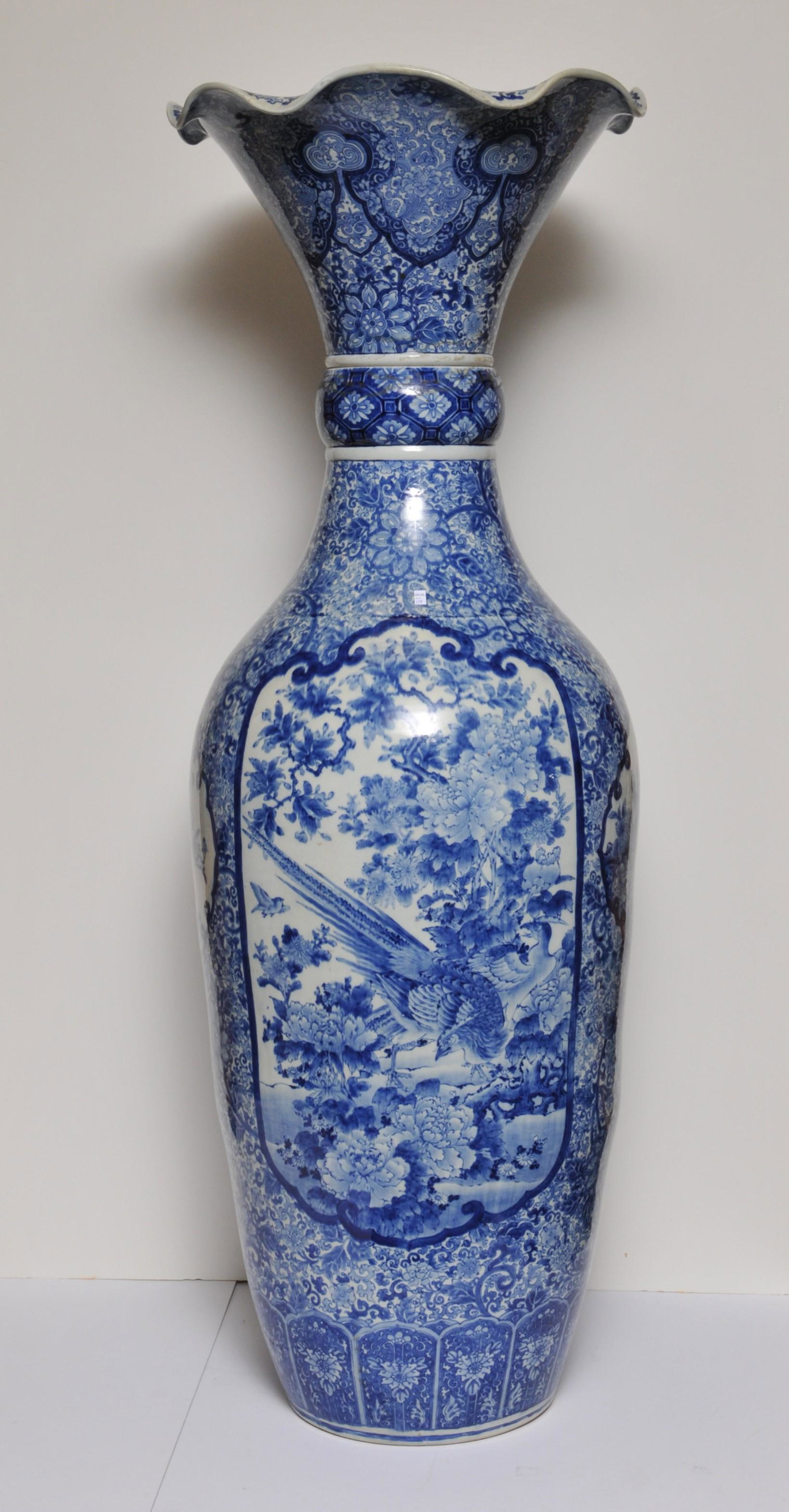 Porcelain palace vase. Japan. Meiji period (1868-1912).: Porcelain palace vase. Japan. Meiji period (1868-1912). Arita ware. Underglaze blue decoration of birds and flowers. Top ruffle portion is removable. 60"H. From the estate of Frank Giuffrida. Late own