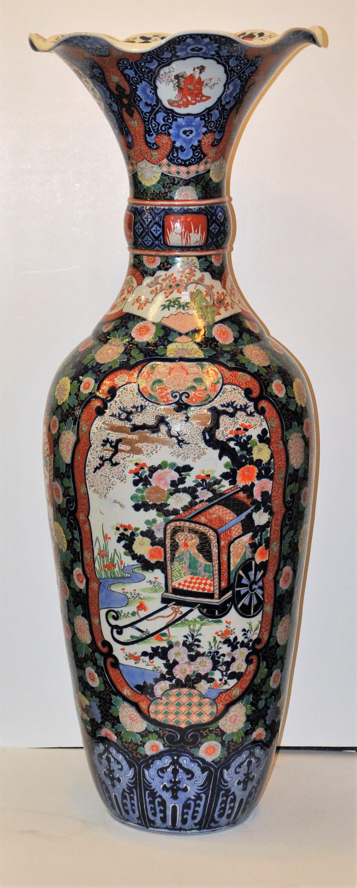 Porcelain palace vase. Japan. Meiji period (1868-1912).: Porcelain palace vase. Japan. Meiji period (1868-1912). Imari ware. Probably by Fukugawaa. Ruffled edge. Reserves of woe and ceremonial carriages on a floral ground. 60" high. From the estate of Frank