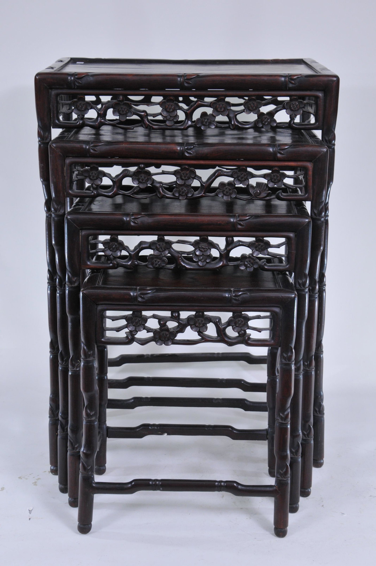 Set of four nesting tables. China. 19th C. Rosewood: Set of four nesting tables. China. 19th C. Rosewood carved with bamboo and flowers. Largest is 28"H.