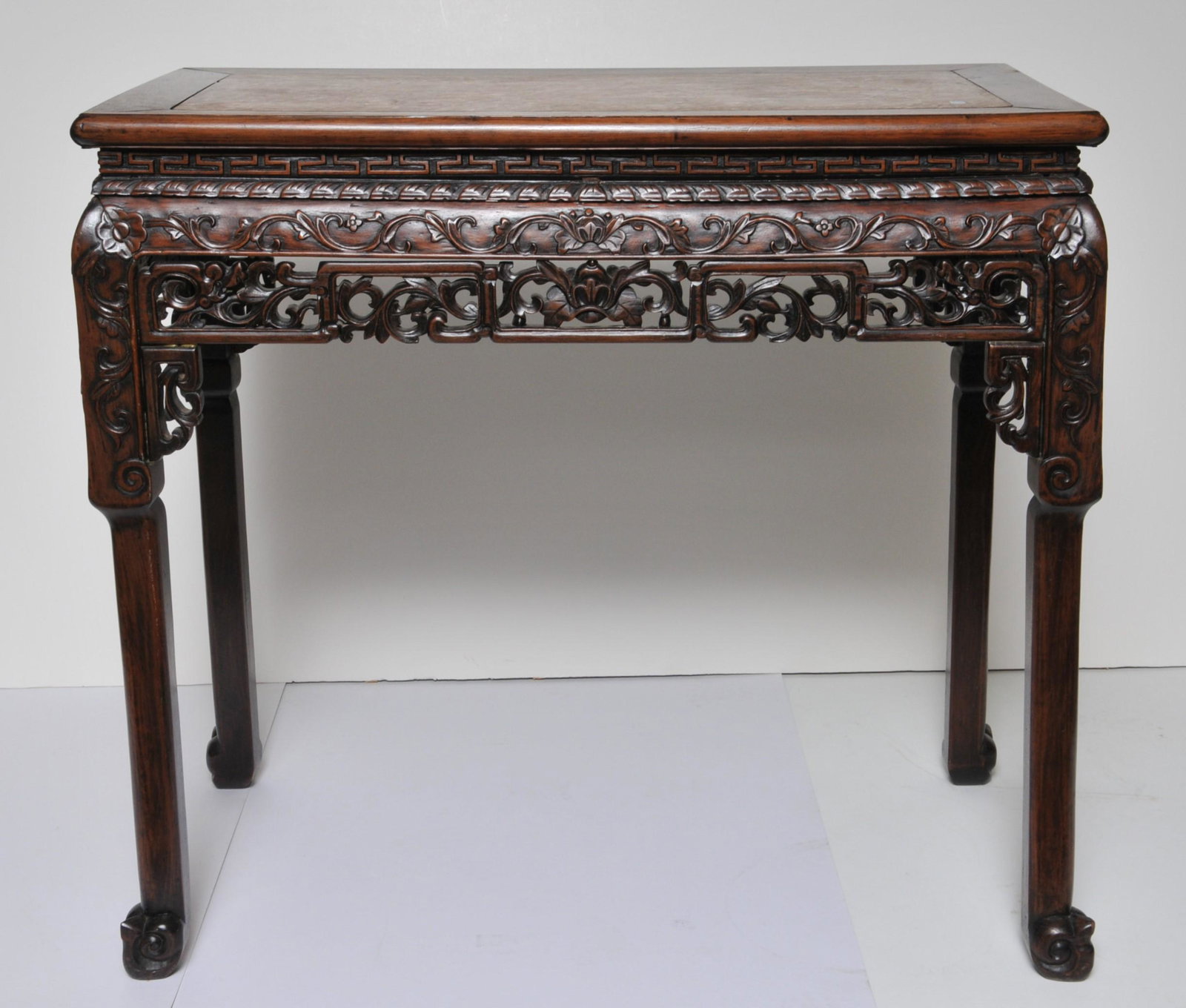 Wine table. China. 19th C. Rosewood aprons carved and: Wine table. China. 19th C. Rosewood aprons carved and pierced with floral work. Red marble inset top. 35" x 32" x 19". Minor wear and chips to apron.