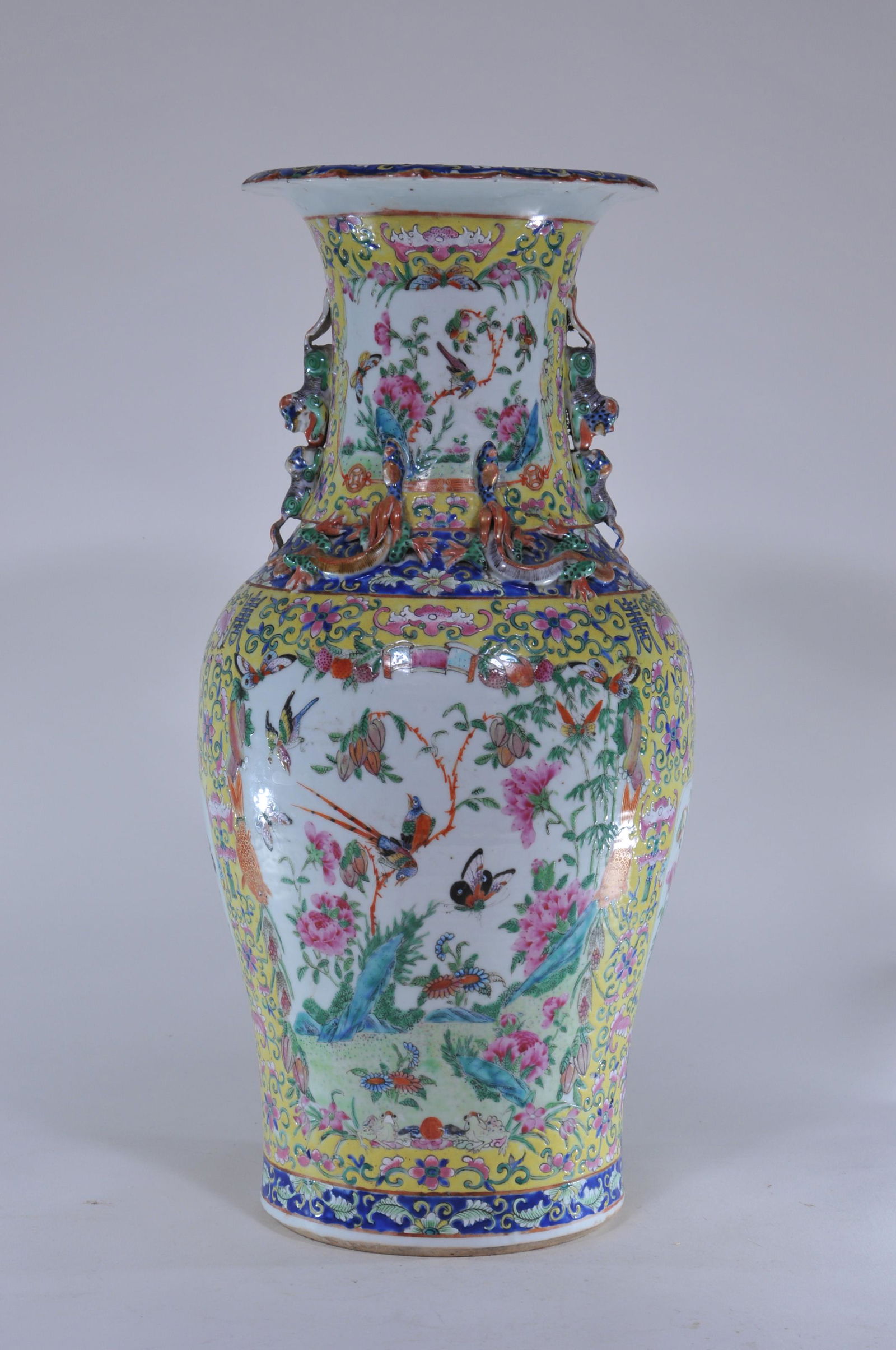 Porcelain vase. China. 19th C. Baluster form. Neck: Porcelain vase. China. 19th C. Baluster form. Neck decorated with moulded dragons and foo dogs. Yellow ground with Famille Rose birds and flowers. 18"H.