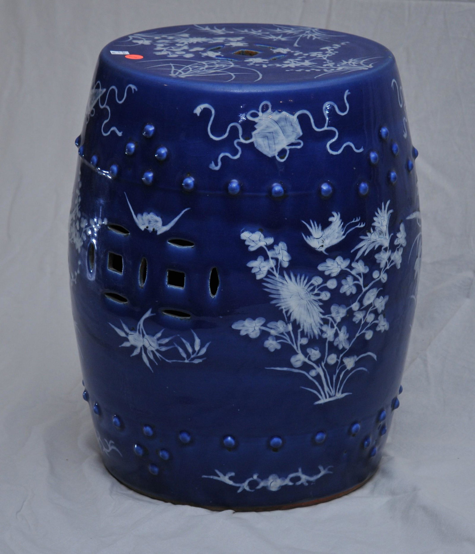Porcelain garden seat. China. 19th C. Pate sur pate: Porcelain garden seat. China. 19th C. Pate sur pate decoration of floral sprigs on a deep blue ground. 19"H.