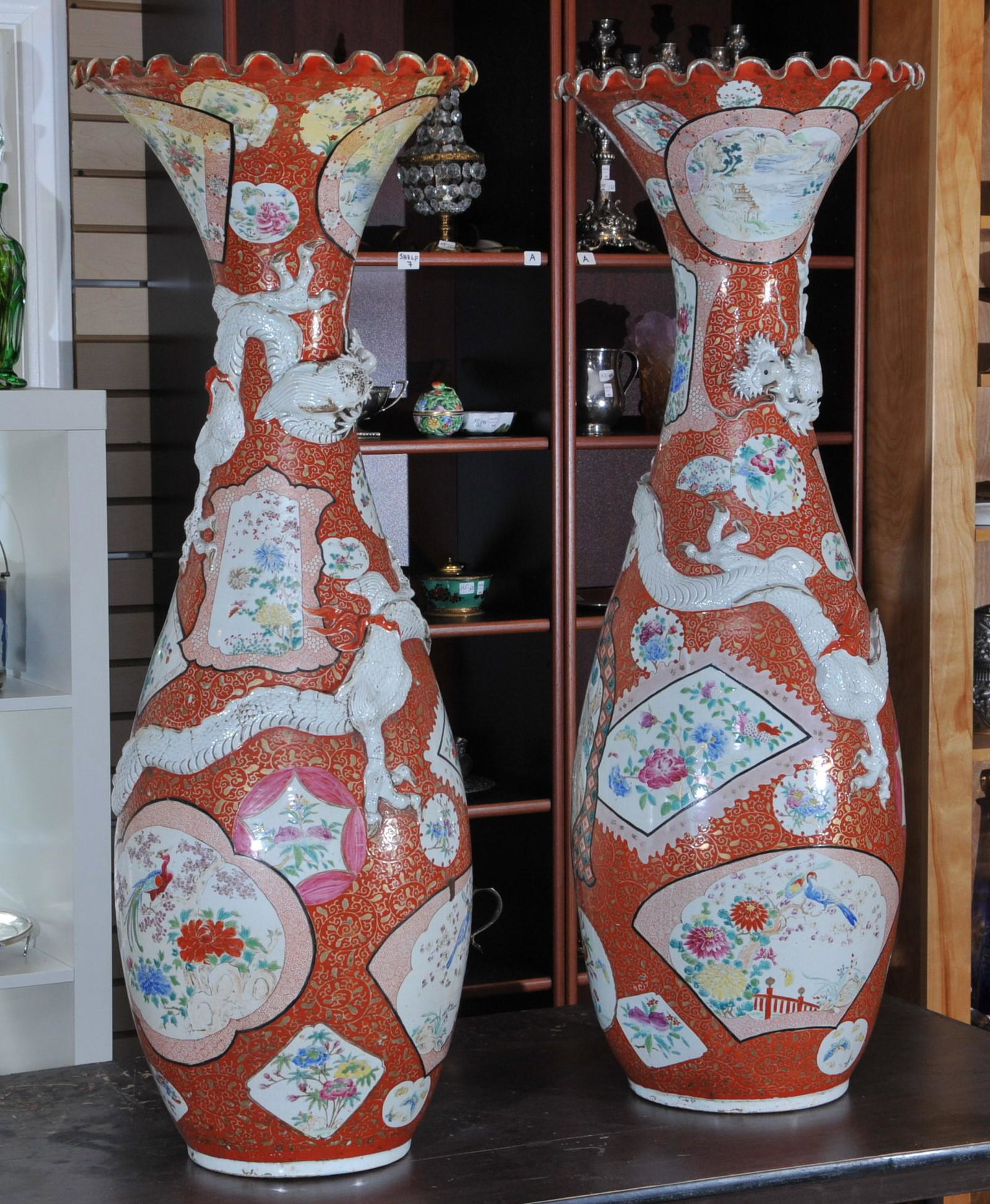 Pair of large vases. Japan. Meiji period (1868-1912.: Pair of large vases. Japan. Meiji period (1868-1912. Kutani ware. Ruffled mouth. Dragons around the body in relief. Decoration of floral scrolled ground. (Both repaired). 43"H. From the estate of Fran