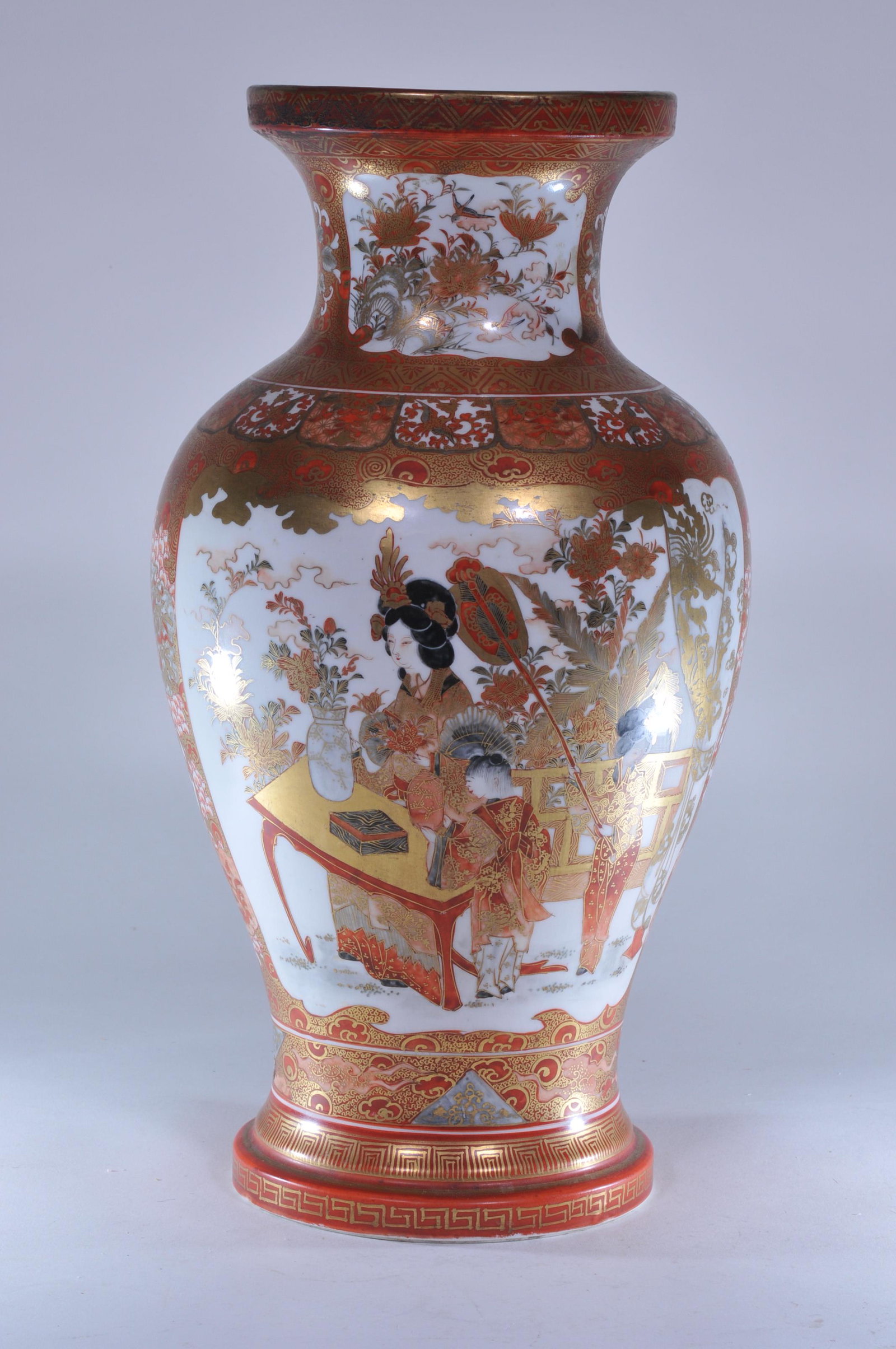 Porcelain vase. Japan. 19th C. Red Kutani ware. Scenes: Porcelain vase. Japan. 19th C. Red Kutani ware. Scenes of women in palace gardens, flowers and birds with various brocade patterns. Drilled for a lamp. 14"H.