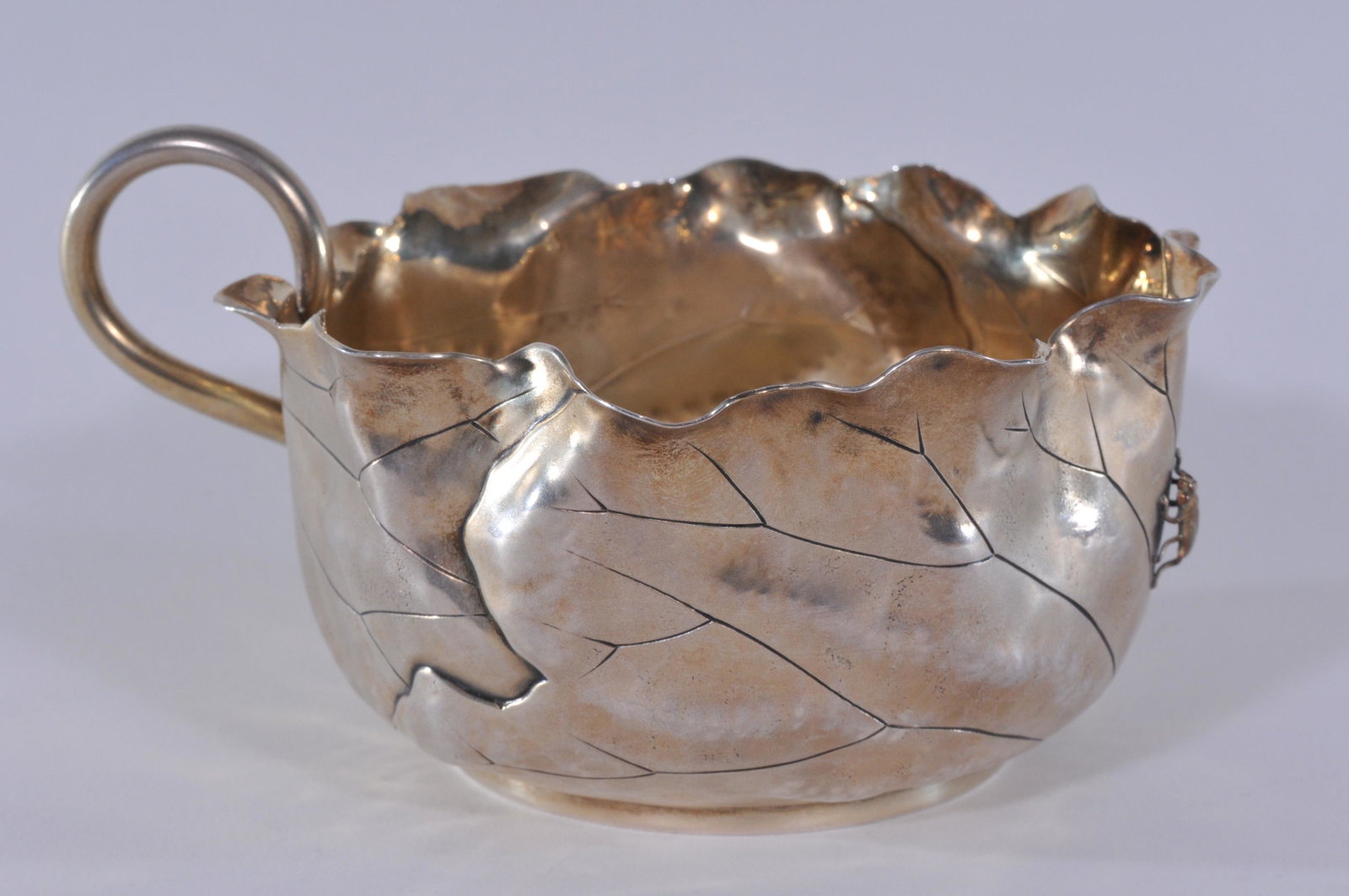 Sheibler gilt sterling silver Aesthetic leaf form mixed: Sheibler gilt sterling silver Aesthetic leaf form mixed metals loop handled scalloped edge serving dish with applied gilt copper bug. Monogrammed on base and dated June 27, 1883. Good condition. 5" di