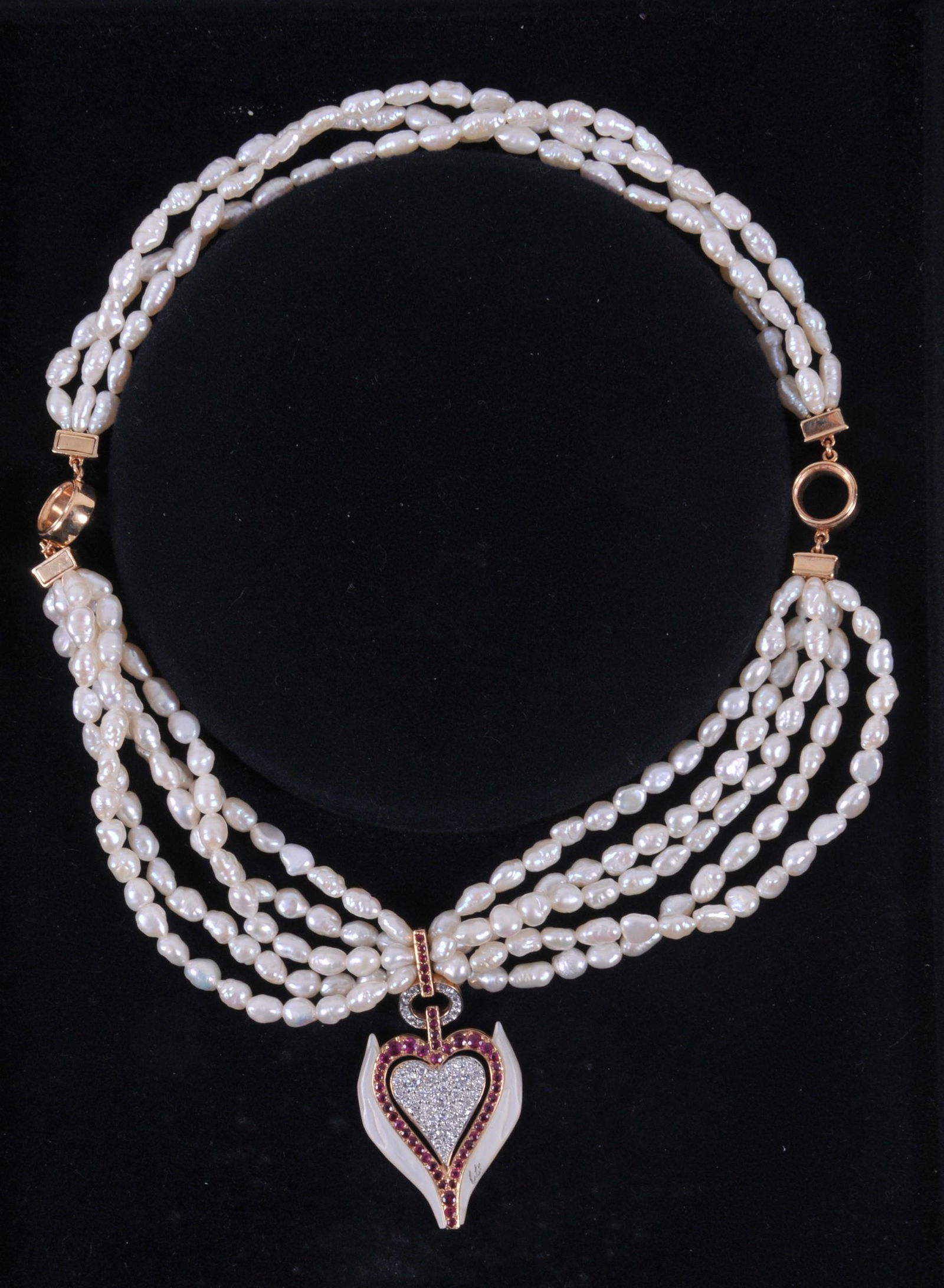 Erte / CFA (Circle of Fine Arts) "Selections of the: Erte / CFA (Circle of Fine Arts) "Selections of the Heart" necklace. Number 40 of 250. Triple strand of freshwater baroque pearls, with a 14k gold heart pendant. Pendant has pave round-brilliant diamo