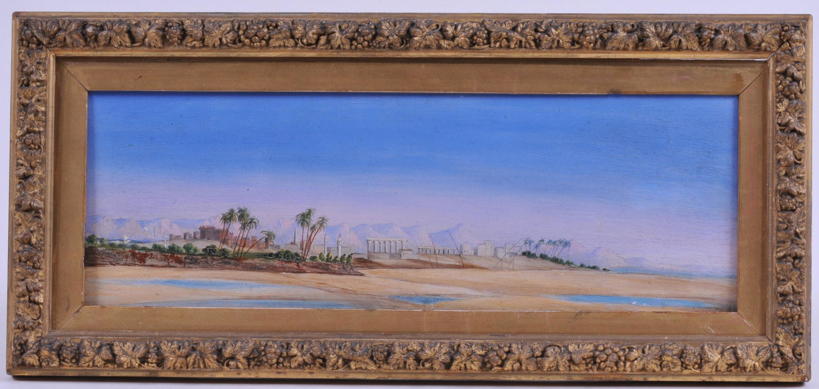 Edward Lear. "Luxor". Colorful small tropical landscape: Edward Lear. "Luxor". Colorful small tropical landscape painting with classical ruins, palm trees and buildings by a river. Mountains in background. Titled "Luxor" and dated lower right Feb. ?. Signed