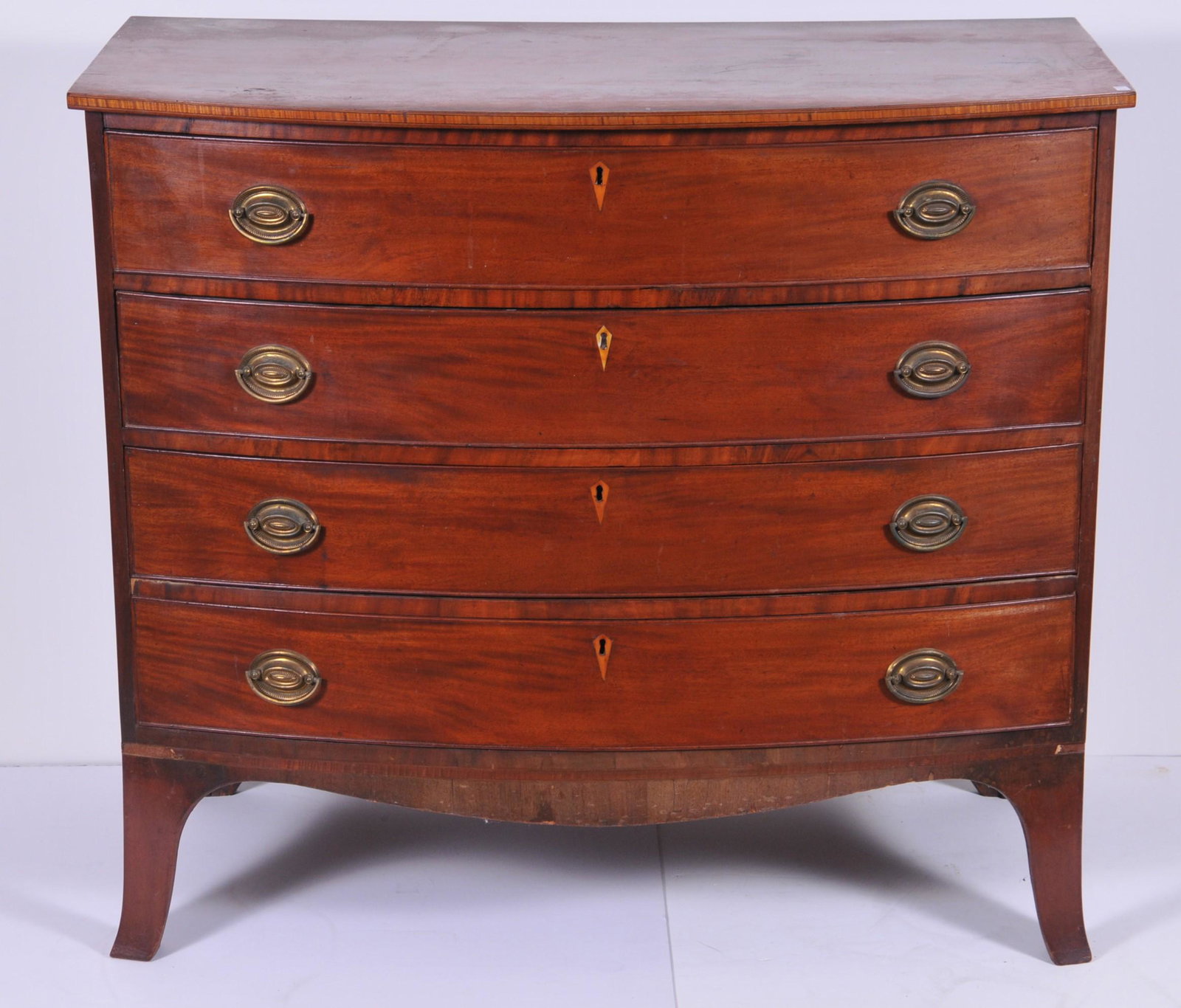 Rare 18th century Boston Hepplewhite mahogany bow front: Rare 18th century Boston Hepplewhite mahogany bow front chest Labeled "Tucker & Griffin". Boston. Circa 1790. The nicely figured one board top with a maple inlaid edge above four long drawers with ori
