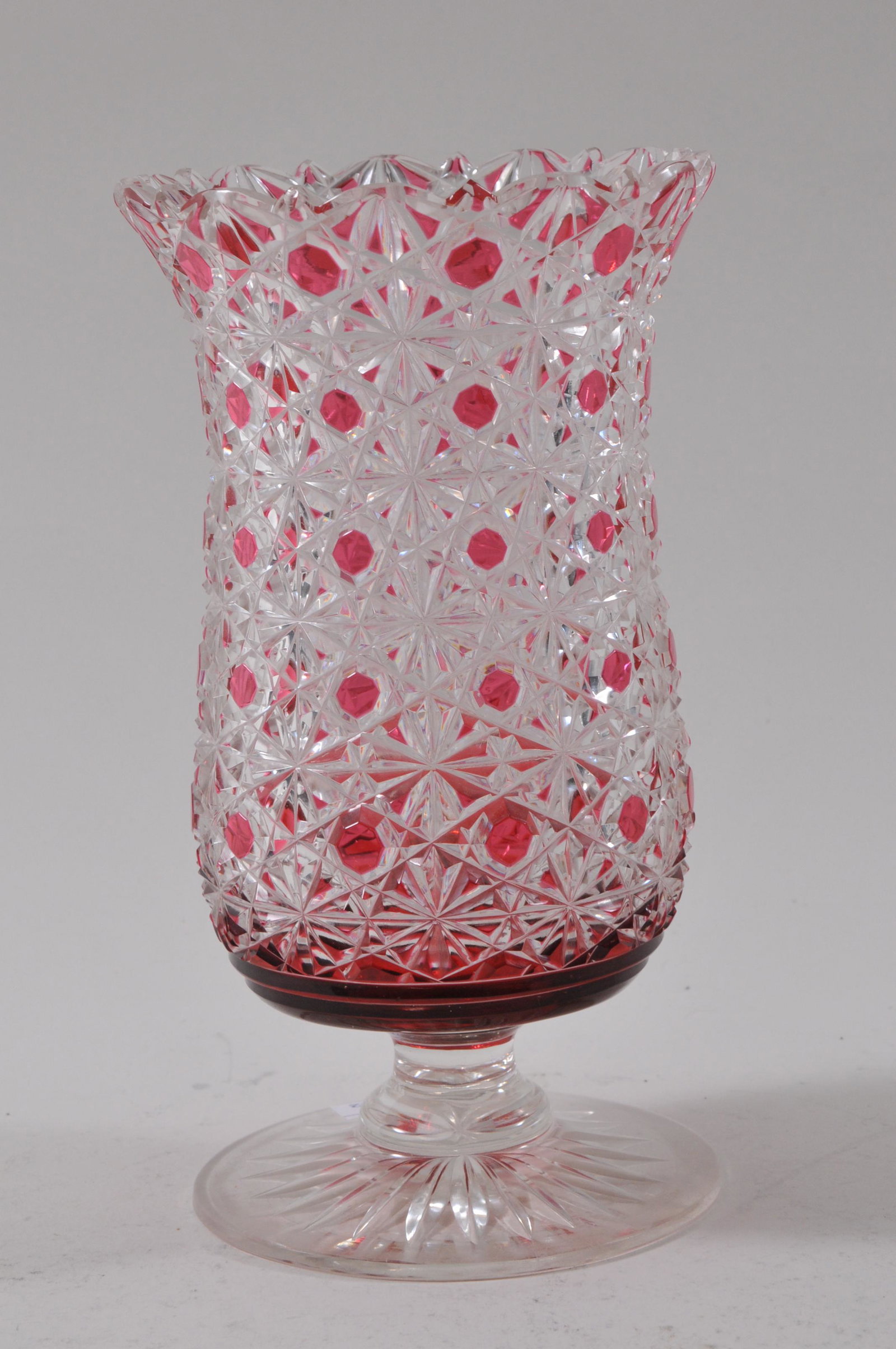 Brilliant cranberry cut to clear Daisy and Button: Brilliant cranberry cut to clear Daisy and Button spooner celery vase with star cut base. Couple of small nicks at top edge. 7-1/2" high.
