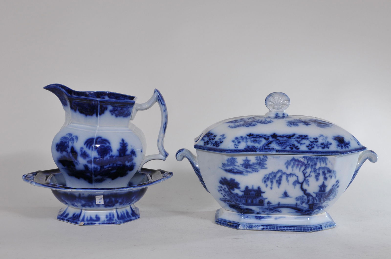 Lot of three 19th century Flow Blue porcelain pieces.: Lot of three 19th century Flow Blue porcelain pieces. To include: (1) Covered tureen. Marked Hindlestan Maddock. With cut corners. Asian landscape scene. No ladle. 11" wide (not including handles) , 8
