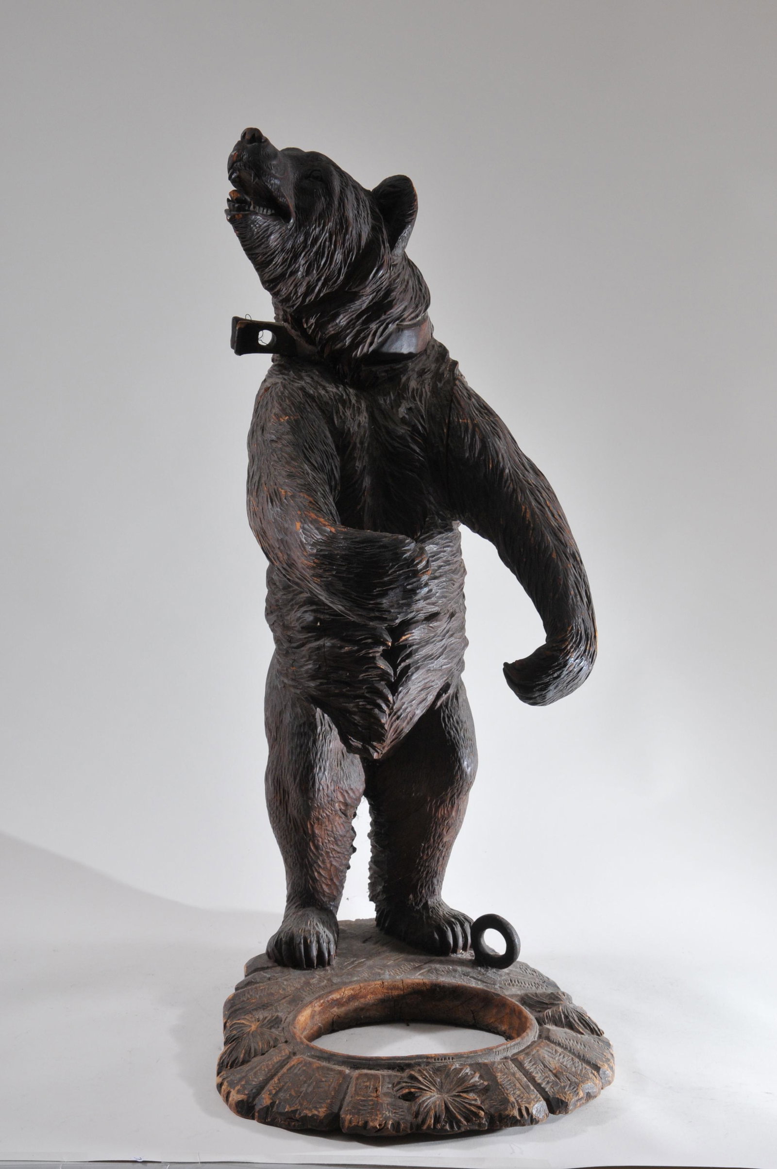 Antique Black forest carved bear form umbrella stand: Antique Black forest carved bear form umbrella stand with glass eyes. Even wear and some chips, missing tray. Arms loose. Height 33 ½Â” Width 15Â”. Depth 17Â”