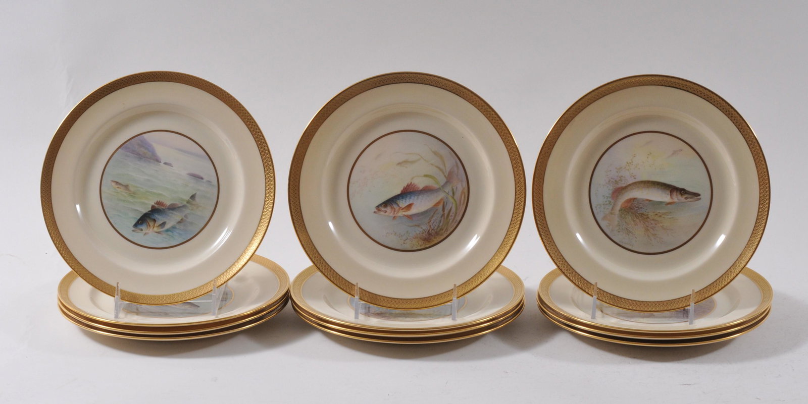Set of twelve Lenox porcelain fish plates decorated by: Set of twelve Lenox porcelain fish plates decorated by W.H. Morley and retailed by J.E. Caldwell & Co. Philadelphia. Each with a fish portrait in the center and raised gilt decorated borders. Each fis