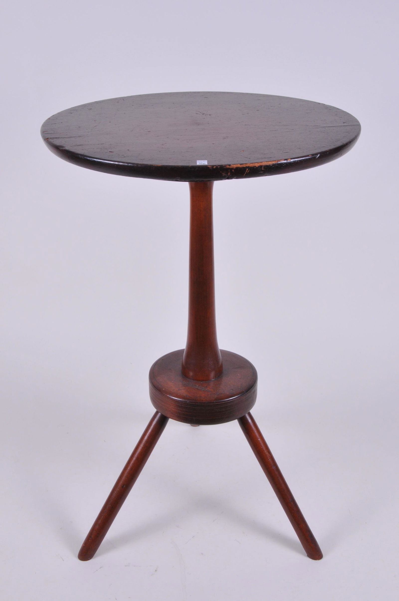 19th century American Shaker style round top candle: 19th century American Shaker style round top candle stand. Three leg base. Tapered shaft with turning at each end. Pine round top. Large champhored cleat. Wood appears to be cherry and birch. 28-1/2"