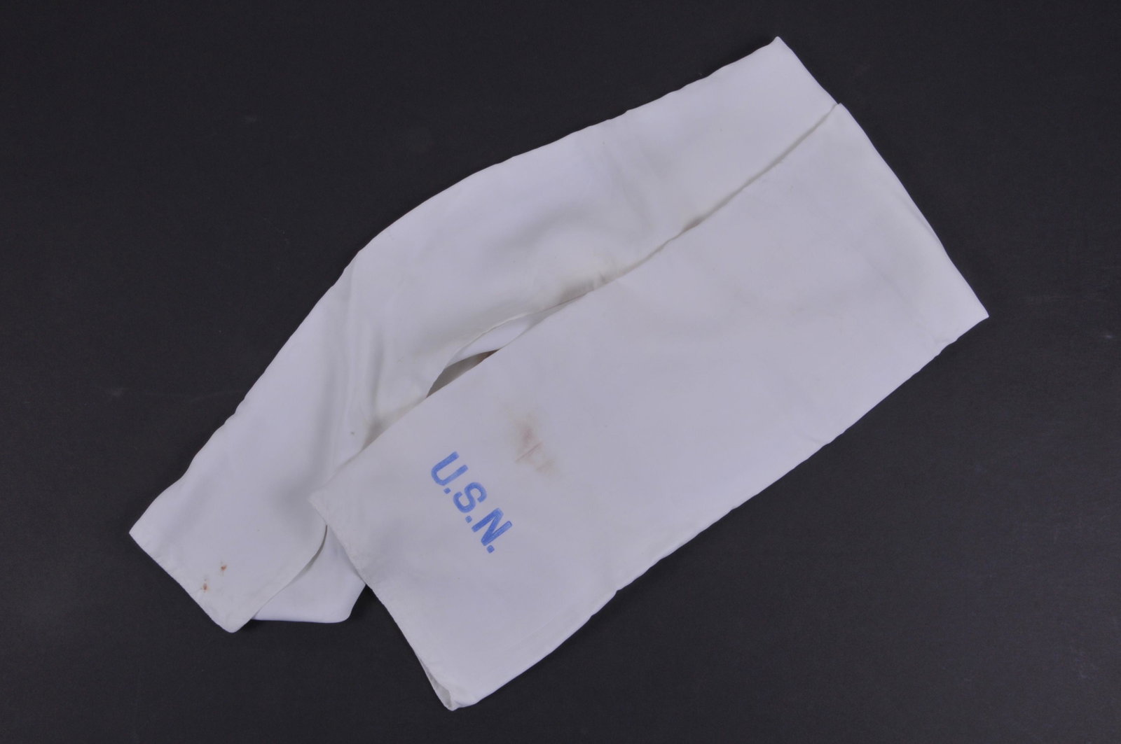 WWII Navy Pilots White Heavy Silk Scarf marked U.S.N.: WWII Navy Pilots White Heavy Silk Scarf marked U.S.N. twice in Blue ink. With some soil stains, minor 1/8 hole, and tape residue.