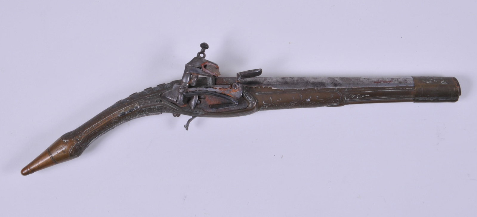 Very Ornate Middle Eastern Brass Overlay Flintlock: Very Ornate Middle Eastern Brass Overlay Flintlock pistol. 17-1/2" overall approx .54 Cal. 9-1/2" BBL. having a brass inlayed cartouche with a Hemp Leaf and the initials of "TC" 3-1/2" long early styl