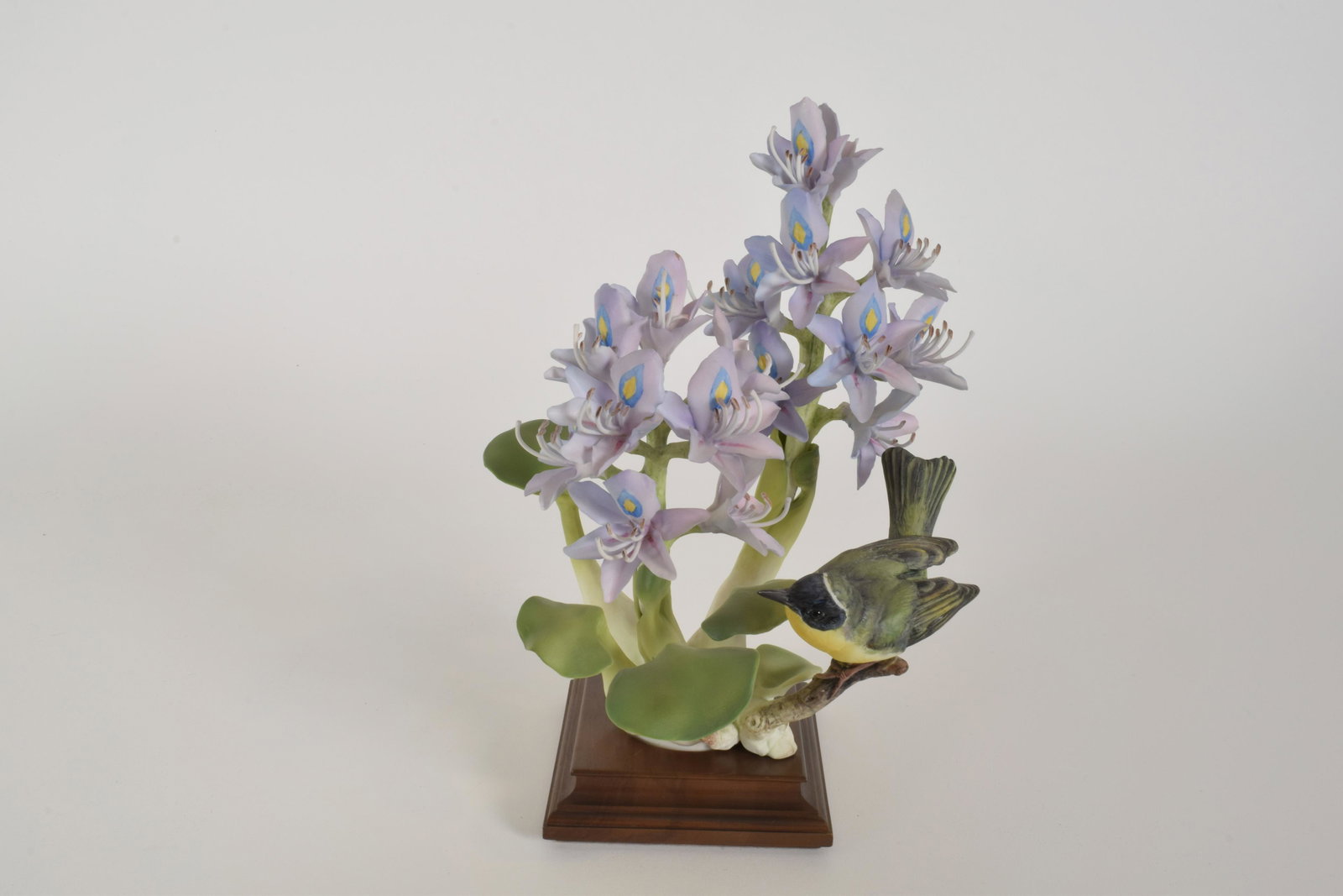 Dorothy Doughty for Royal Worcester "Yellow Throat and: Dorothy Doughty for Royal Worcester. Bone China "Yellow Throat and Water Hyacinth," made in England. Approximately 12" high and 8" at widest point. With box. Minor losses to pistols.
