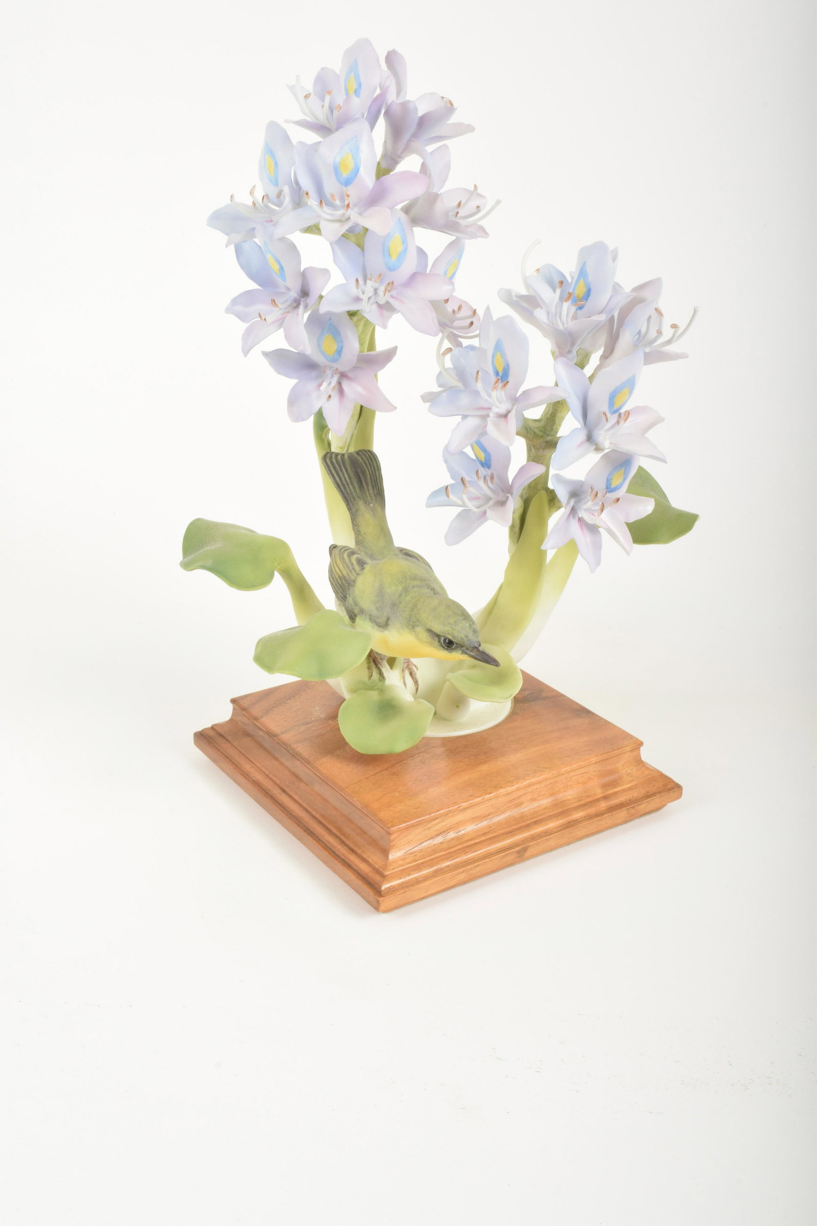 Dorothy Doughty for Royal Worcester "Yellow Throat and: Dorothy Doughty for Royal Worcester. Bone China "Yellow Throat and Water Hyacinth," made in England. Approximately 12" high and 9" at widest point. With box. Minor losses to pistols (one piece include