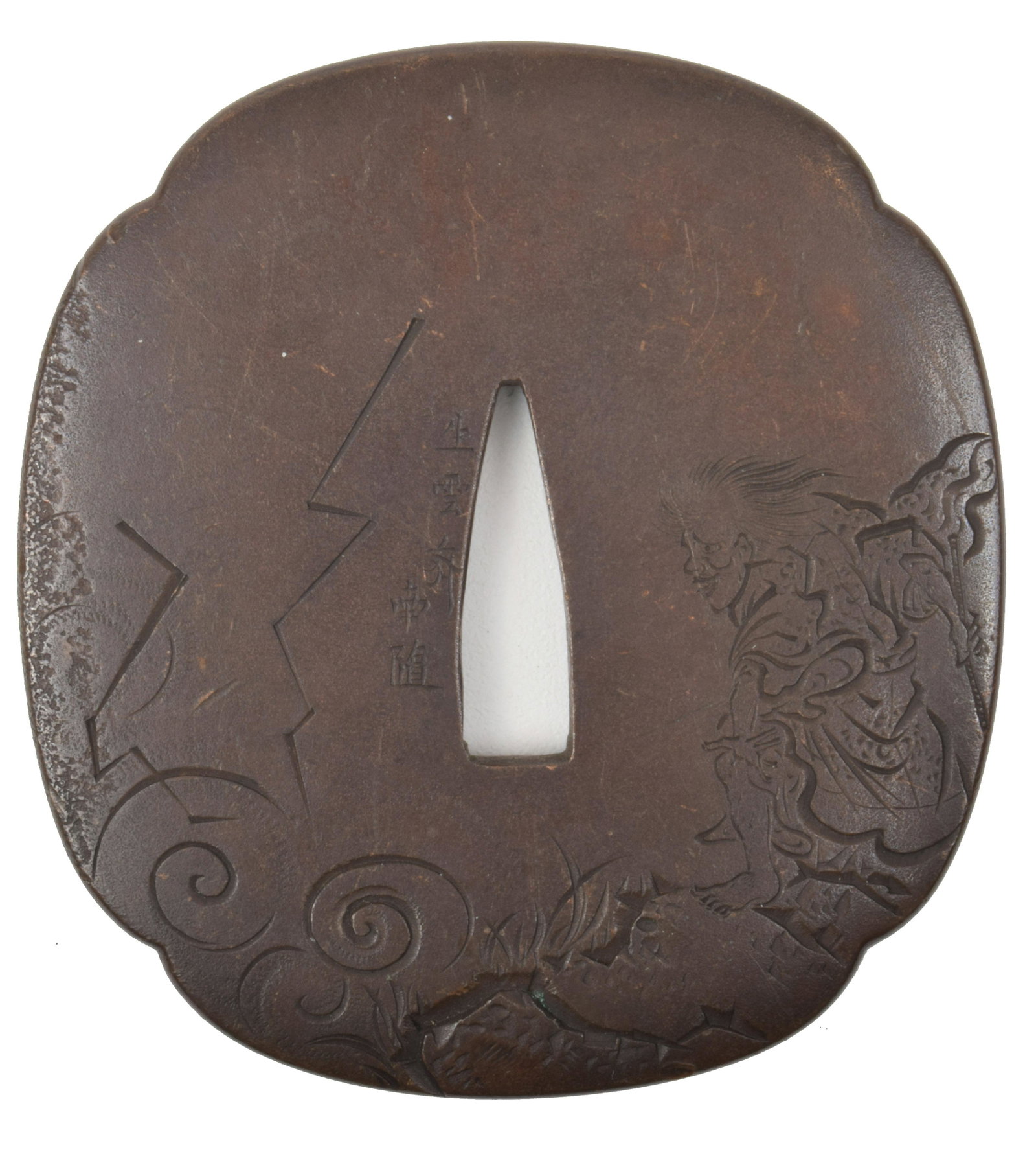 Shakudo Mokko-Form Tsuba: Shakudo mokko-form tsuba. Signed, 19th Century, engraved with Raiden, the god of lightening, with lightening crashing around. 2 ¾” x 3”.