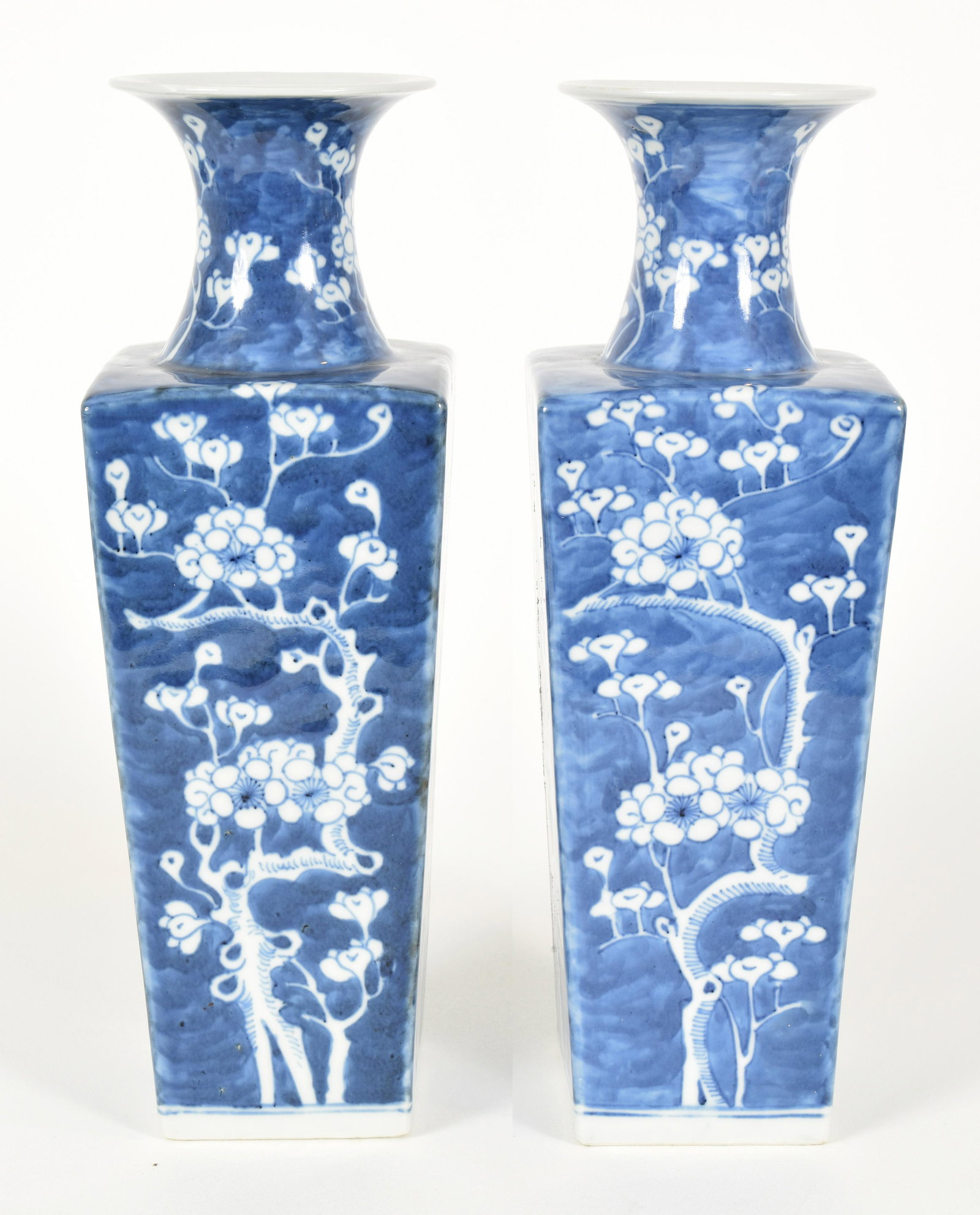 Pair of Porcelain Vases, Early 20th Century: Pair of porcelain vases. China. Early 20 th Century. Squared baluster form. Underglaze blue decoration of flowering prunus. 11-1/2” high.