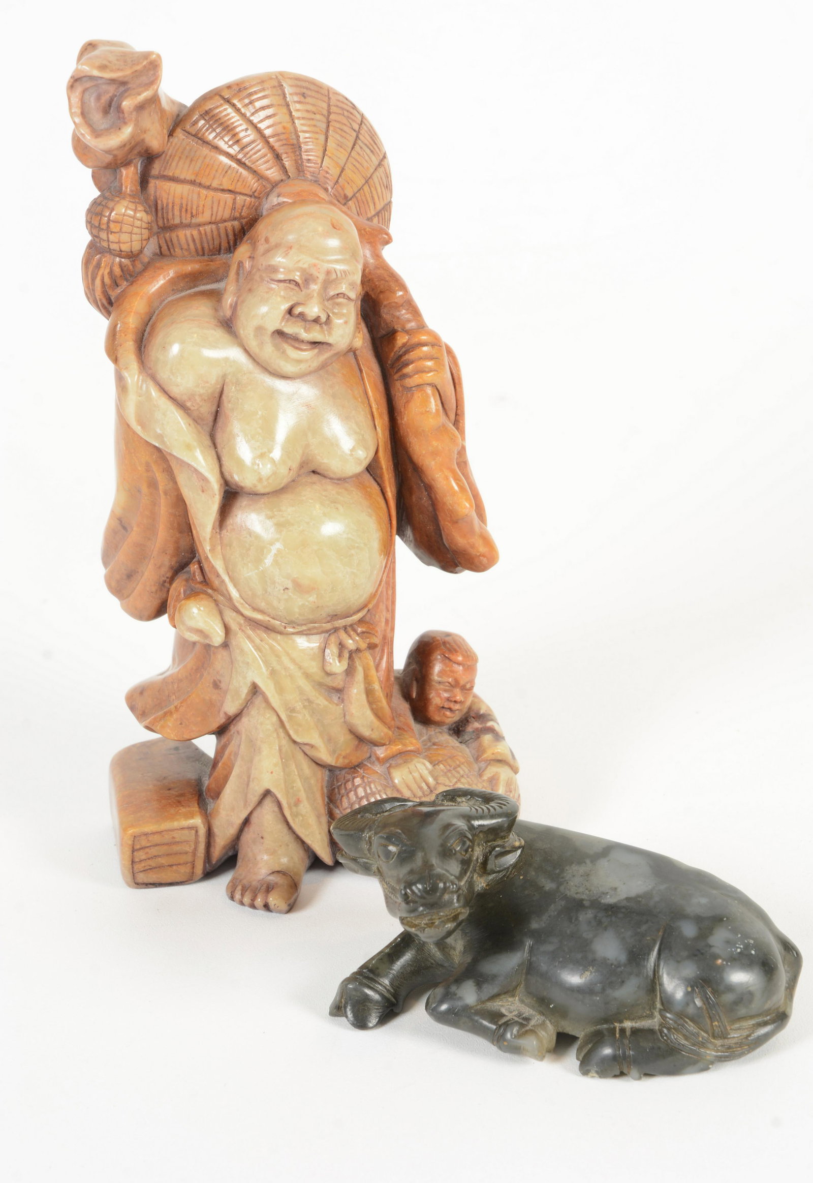 Two Soapstone Carvings: Two soapstone carvings. China. Early 20 th Century. A black water buffalo and a figure of Milofu. 3-1/2” and 7-1/4”.