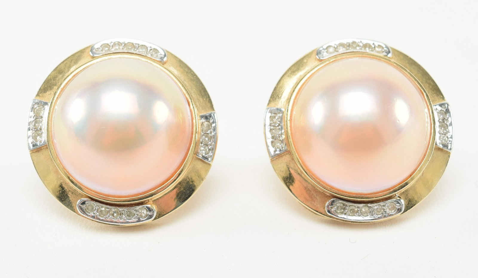 14K Gold Mabe Pearl and Diamond Earrings: 14k gold mabe pearl and diamond earrings. Pearls are pink color, high luster, with few blemishes. 16.5mm each, round in shape. Each earring contains 16 small single-cut diamonds. Overall diameter of e