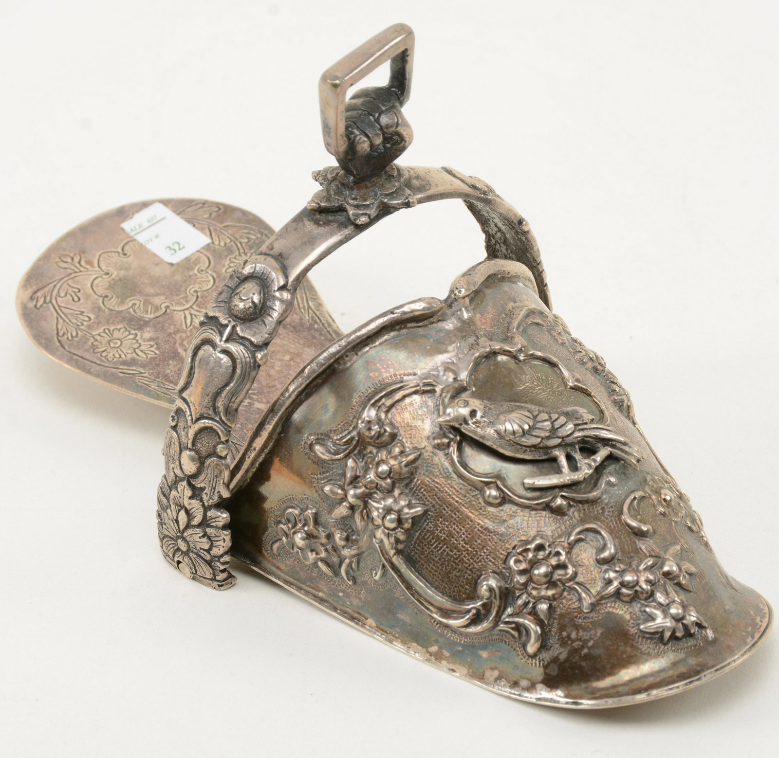 18th Century Embossed Silver Stirrup. Decoration of bid: 18th Century Embossed Silver Stirrup. Decoration of bid and floral scrollwork. Small dents, bends and imperfections consistent with age. 8.25” long.
